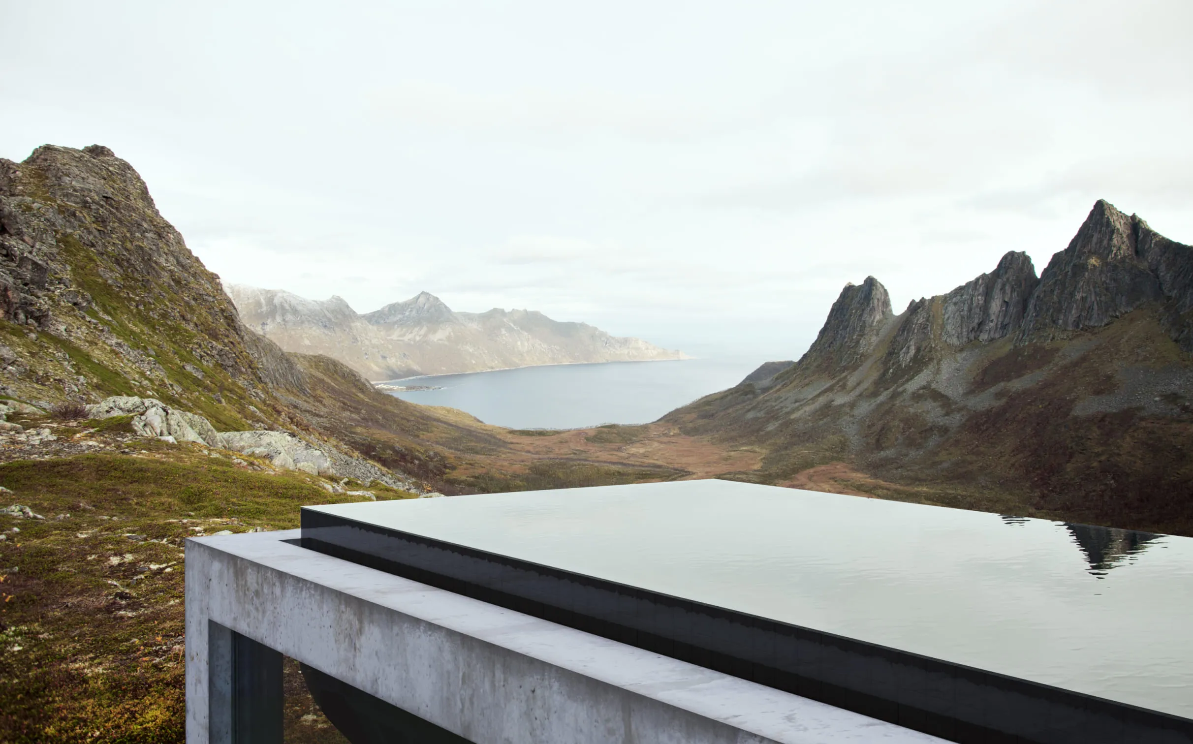 A 3D rendering of a modern building with an infinity pool overlooking a valley and rugged mountains.