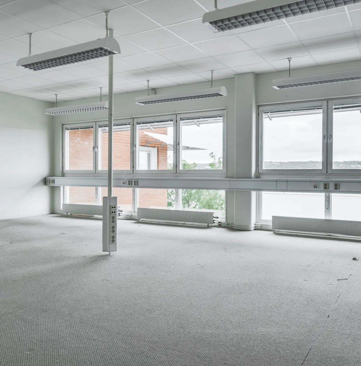 Virtual staging for real estate photos – the example of initial data. Office premises with naked and plain floors and walls.