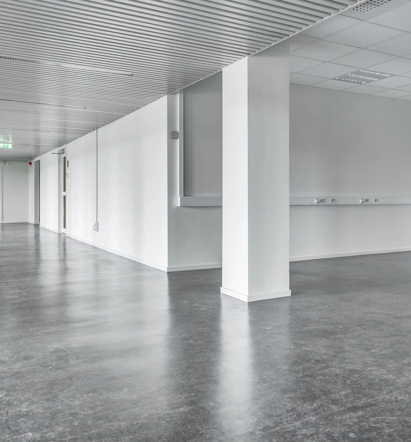 Virtual staging for real estate photos – the example of initial data. Office premises with naked and plain floors and walls.