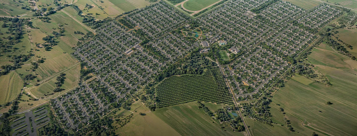 Aerial view of a large suburban neighborhood development surrounded by farmland and green spaces – master-planned community in a construction project portfolio.