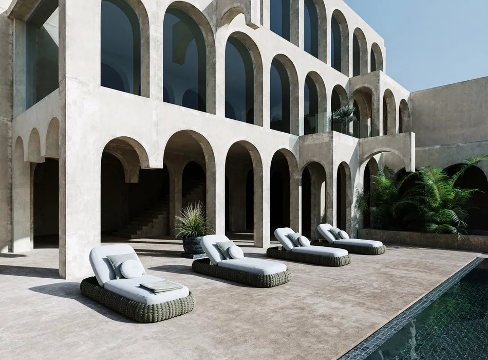 Modern architectural courtyard with large arched concrete structures, featuring outdoor furniture staging of woven sun loungers arranged beside a swimming pool.