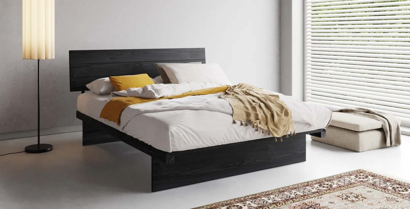 Minimalist staging a bedroom scene with a dark wood platform bed, soft white linens, mustard accent throws, and natural light streaming through large window blinds.