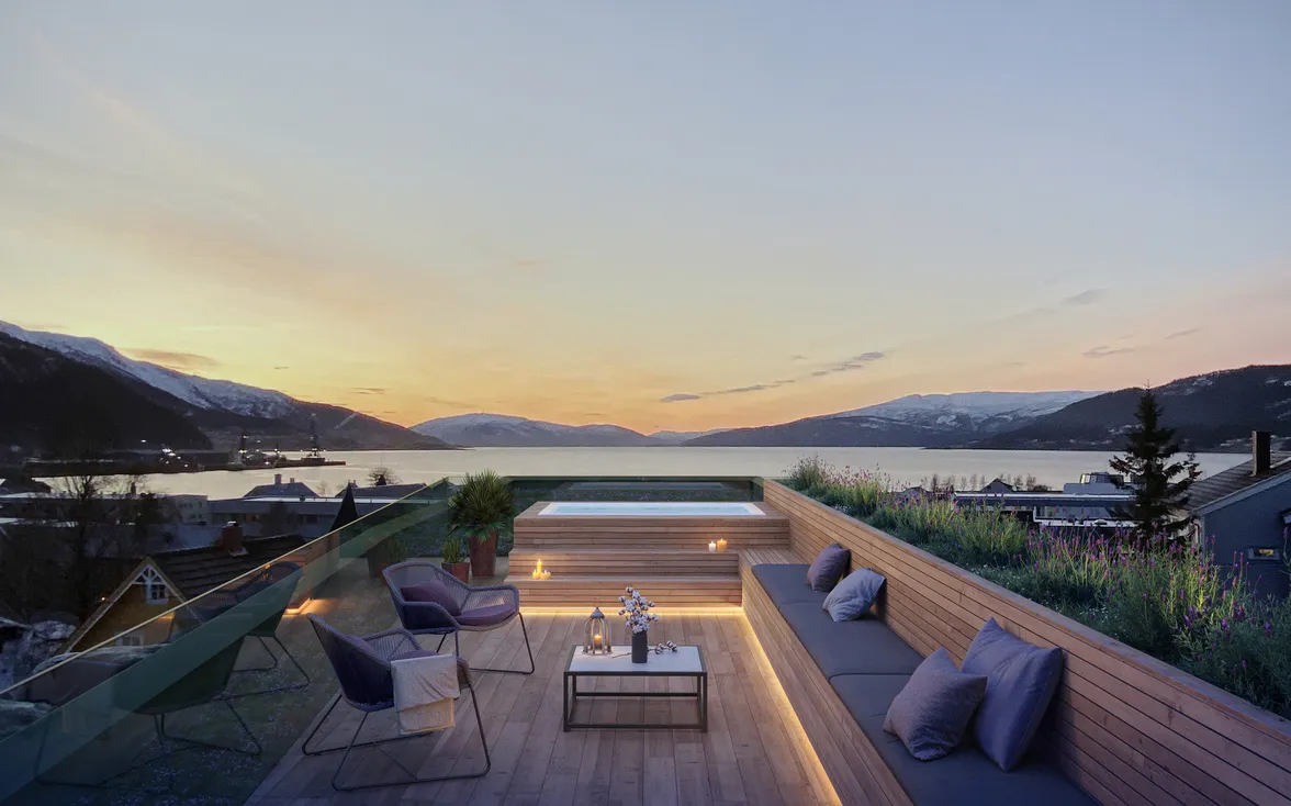 Modern single family home rendering featuring a rooftop terrace with built-in wood seating, ambient lighting, a hot tub, and panoramic mountain and lake views at sunset.