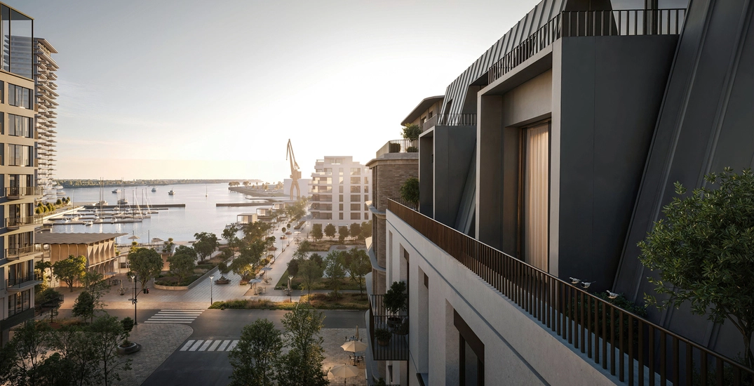 Waterfront cityscape with modern residential buildings and marina views, representing building a real estate portfolio focused on prime urban locations.