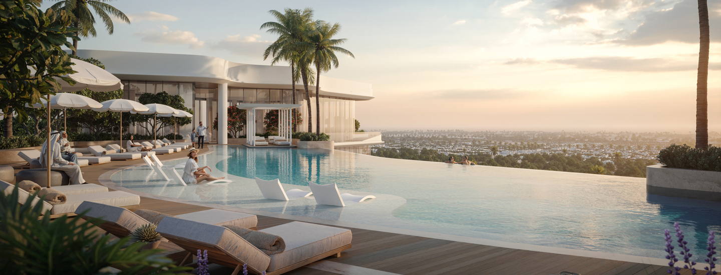 Luxury infinity pool and outdoor lounge area at a residential community, showcasing lifestyle amenities important when building a real estate portfolio.