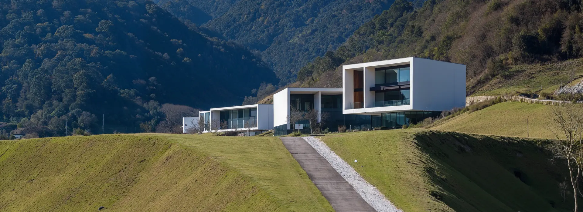 Modern minimalist hillside villa with geometric architecture blending into mountains, concept render exploring will ai replace 3d artists in architectural visualization