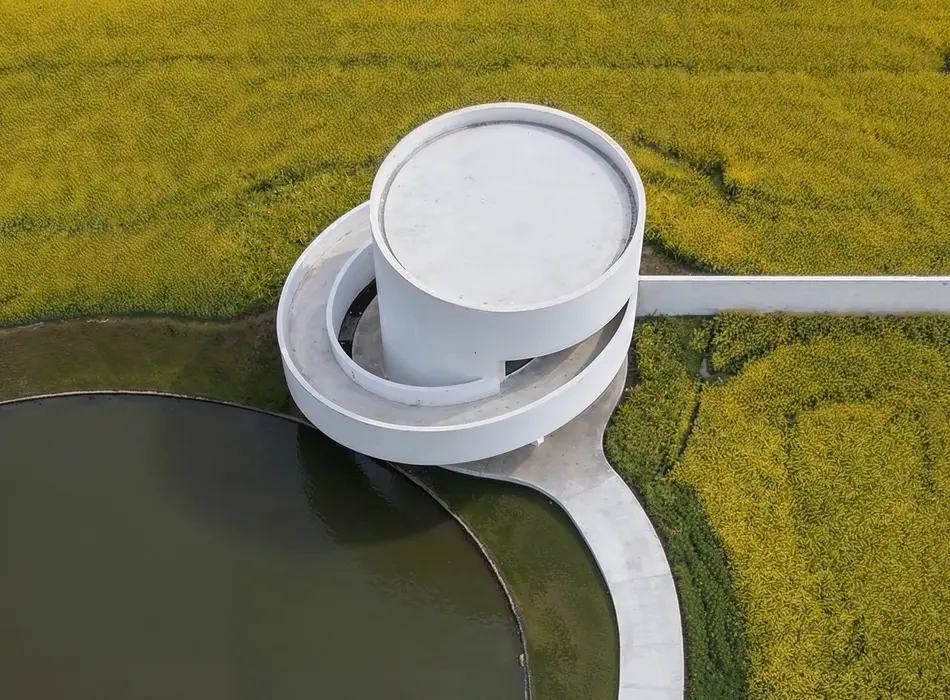 How to make an architecture portfolio showcasing a circular white architectural concept surrounded by fields and water.