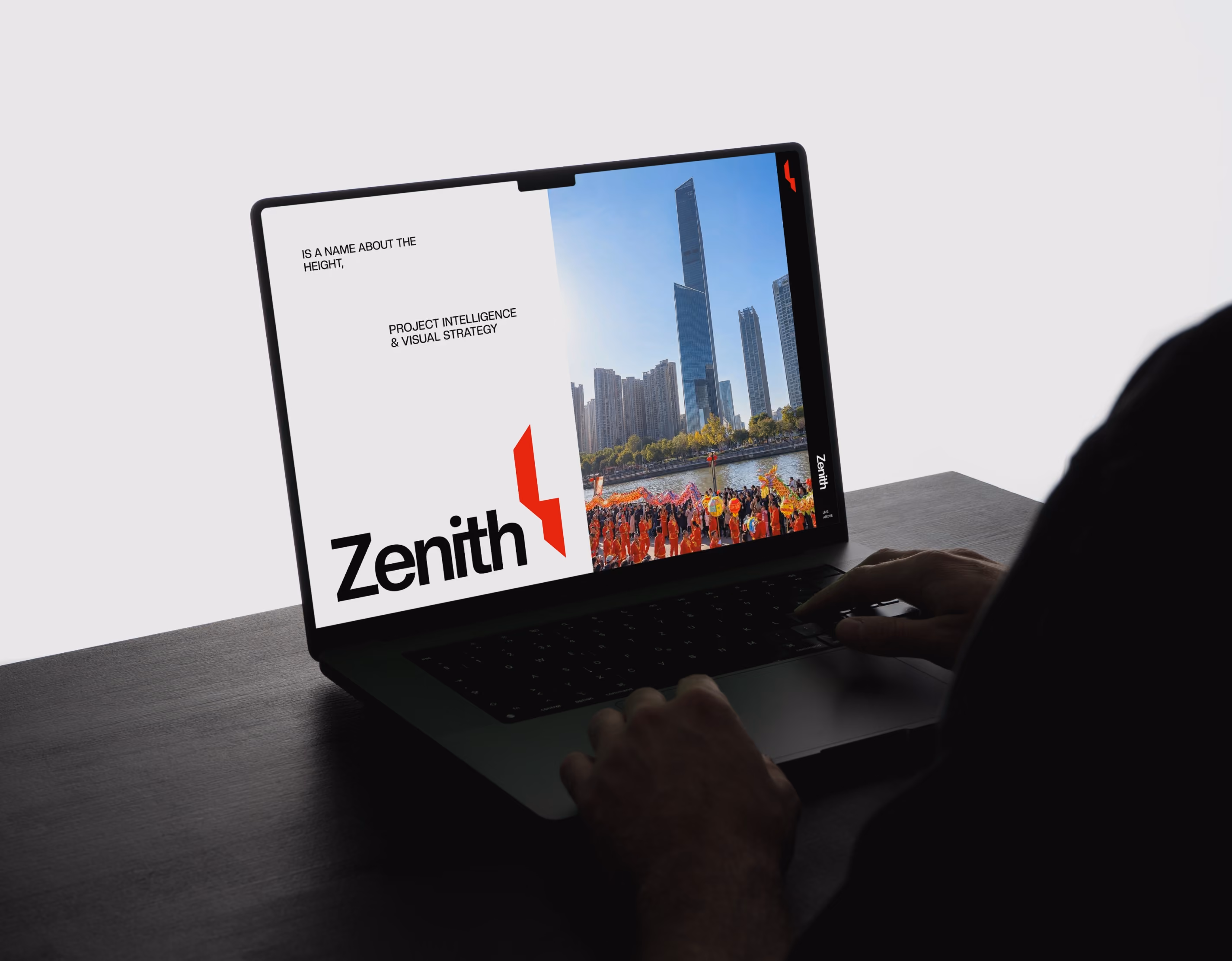 Hands typing on a laptop showing Zenith branding and a city skyline with skyscrapers and a parade.