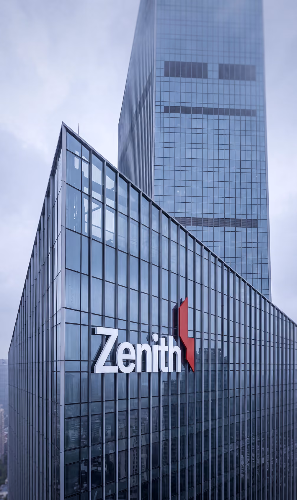 Modern glass skyscraper with Zenith logo in large white letters and a red abstract symbol.