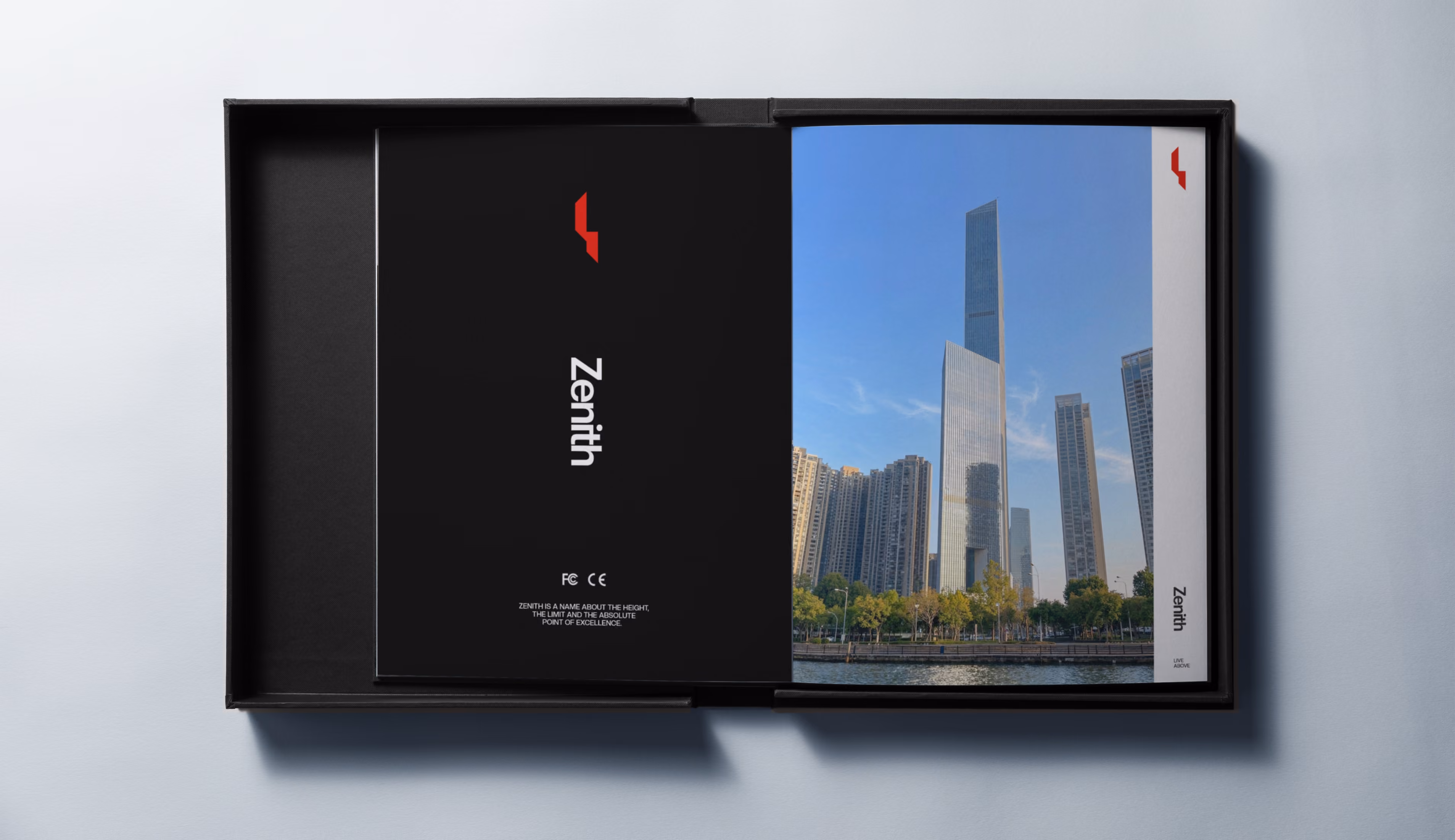 Open black box containing booklets titled Zenith with a city skyline of skyscrapers on one cover.
