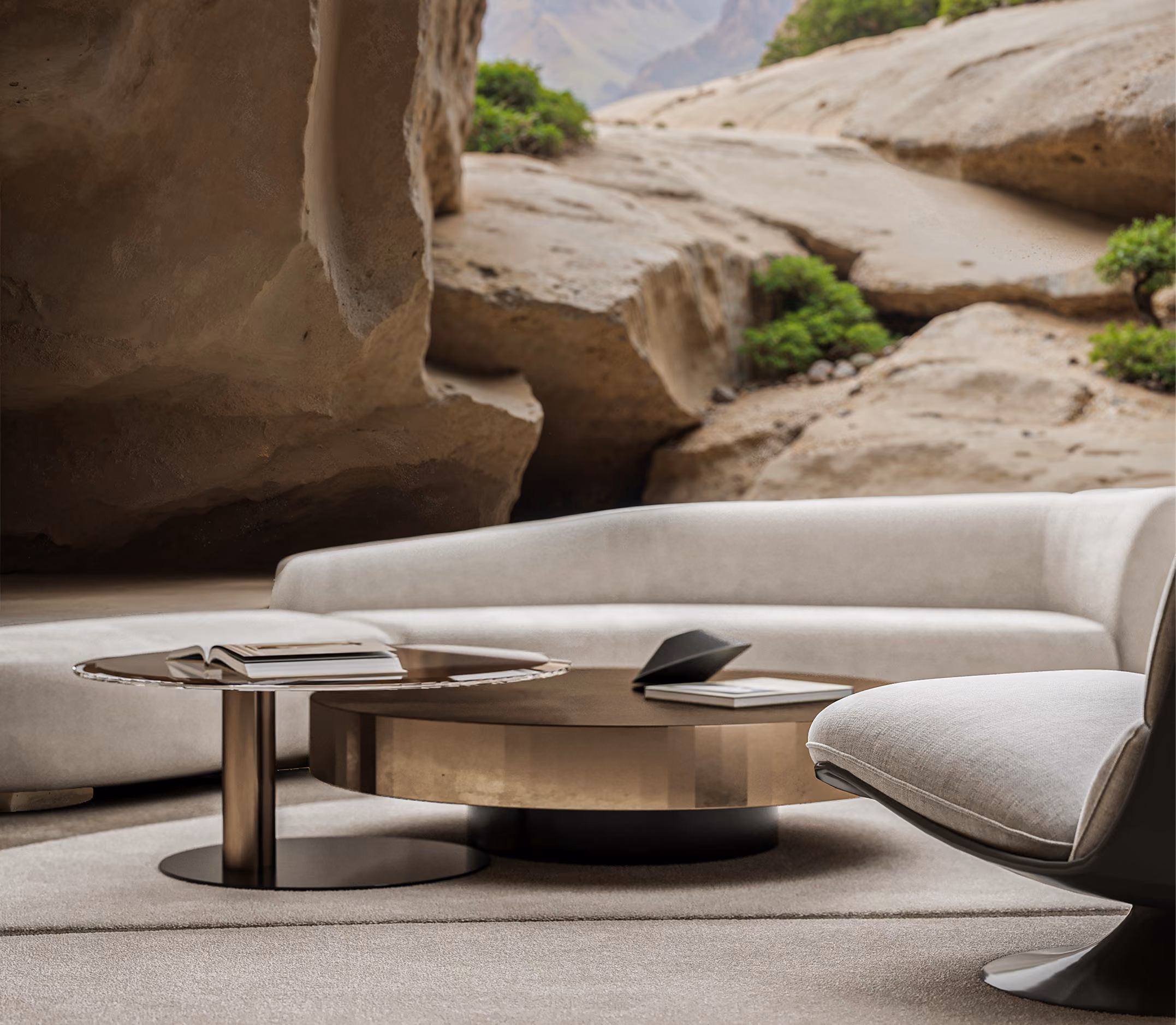 Modern beige living room with curved sofa, round metal coffee tables, and a landscape mural wall.
