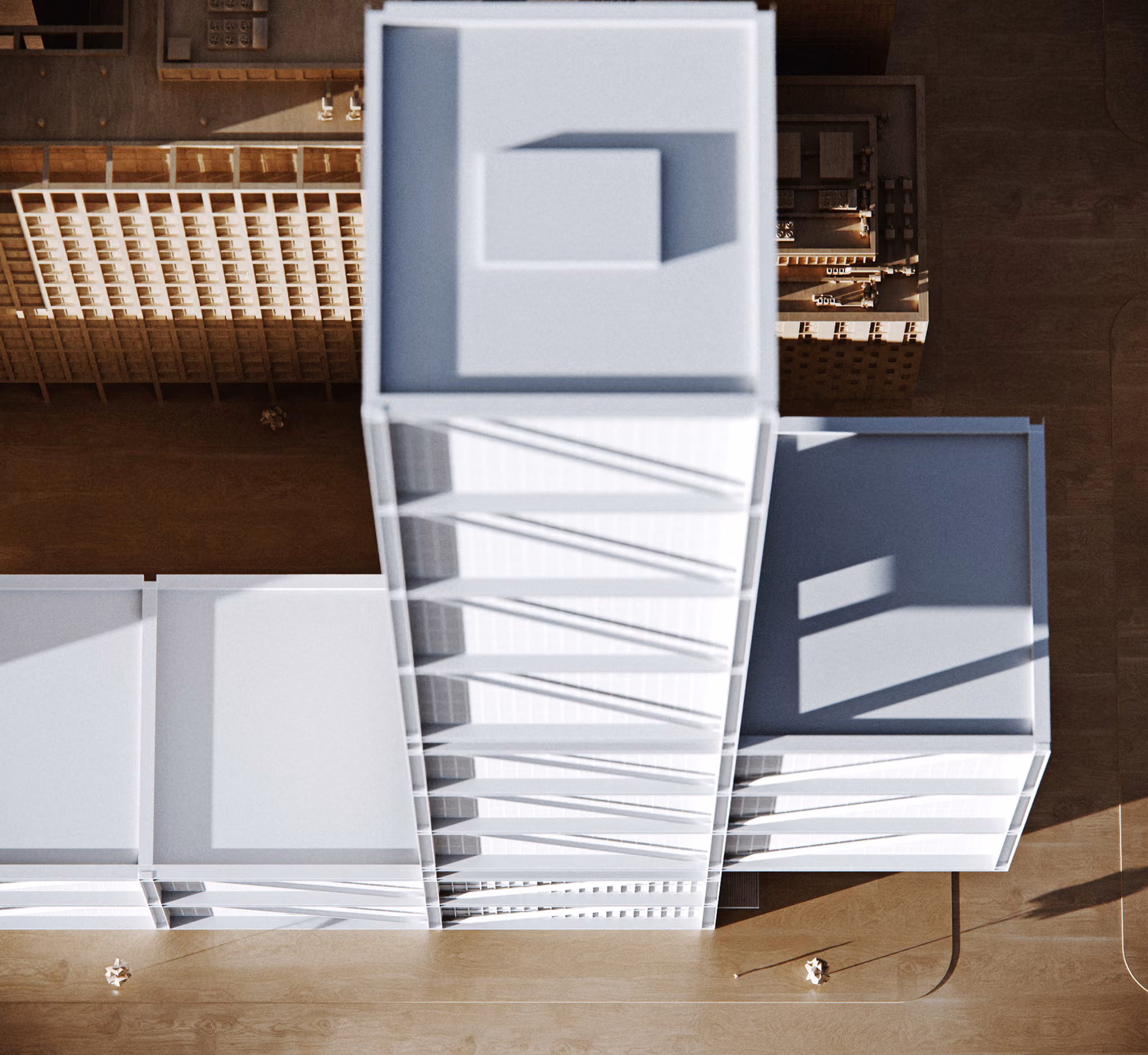 Top-down view of a modern architectural building with angular glass and white structural design.