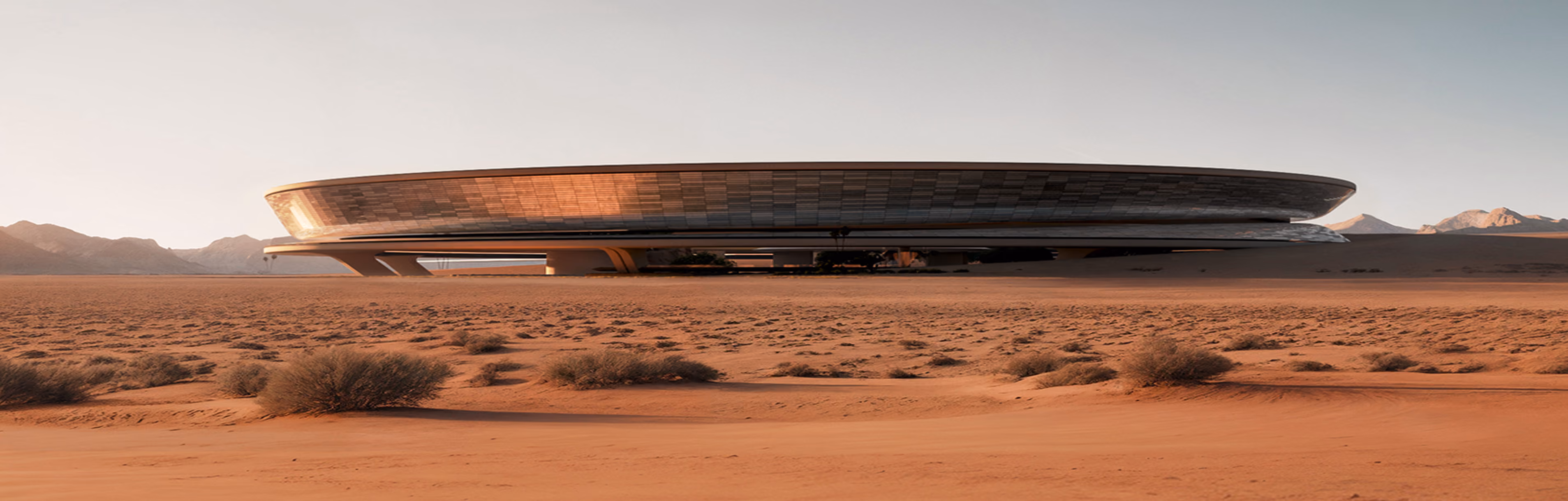 Futuristic oval building with reflective glass walls in a desert landscape with distant mountains.