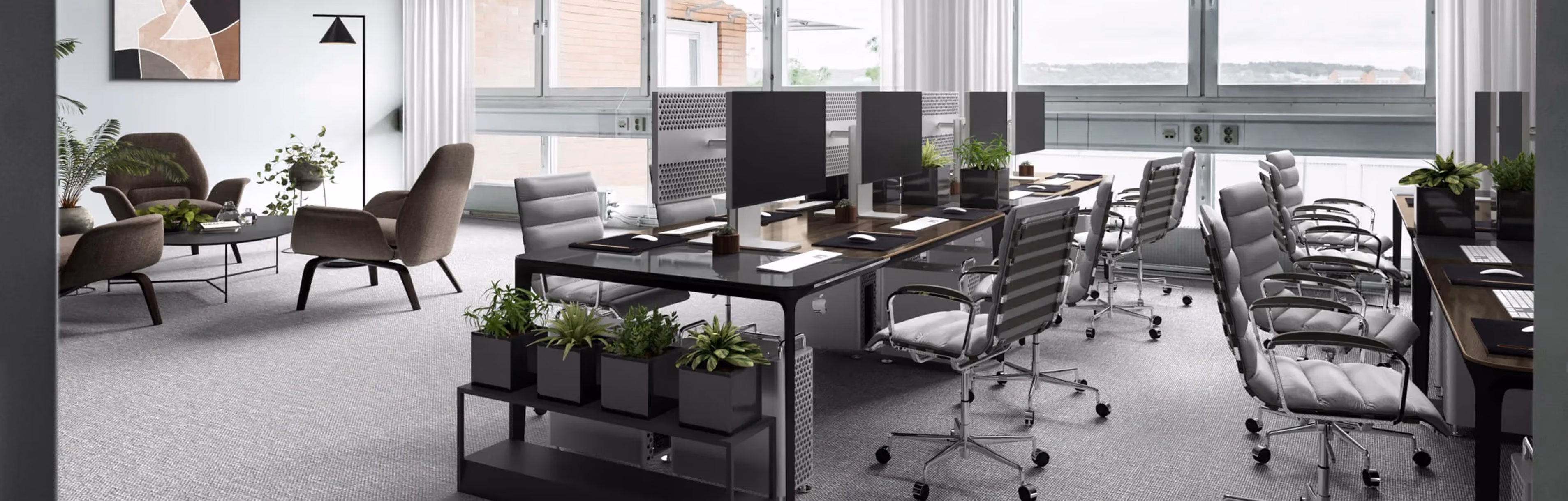 Modern office workspace with black desks, gray chairs, computer monitors, and green plants near windows.