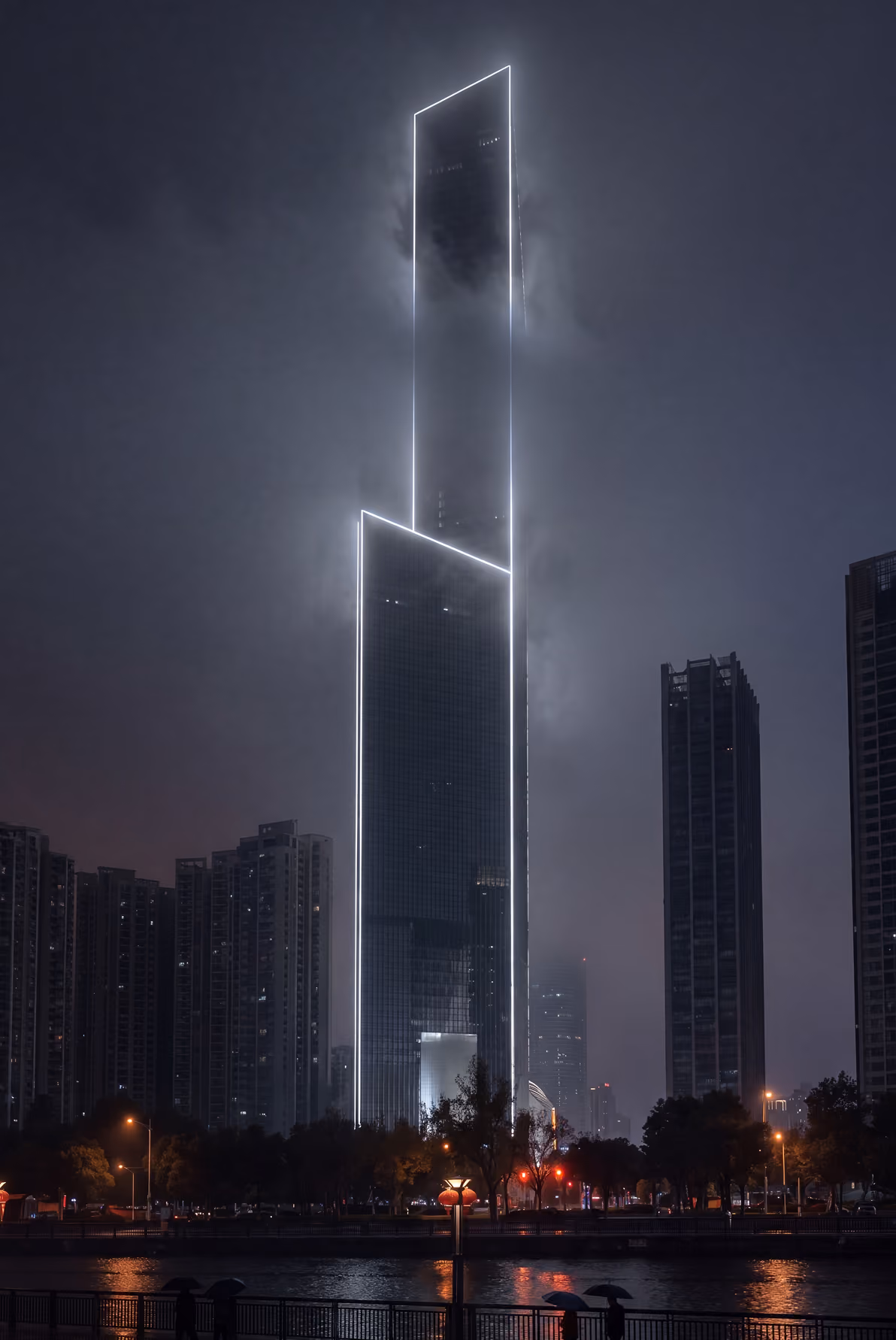Tall modern skyscraper outlined with bright white neon lights at night, partially shrouded in fog, with surrounding buildings and reflections on a river in the foreground.