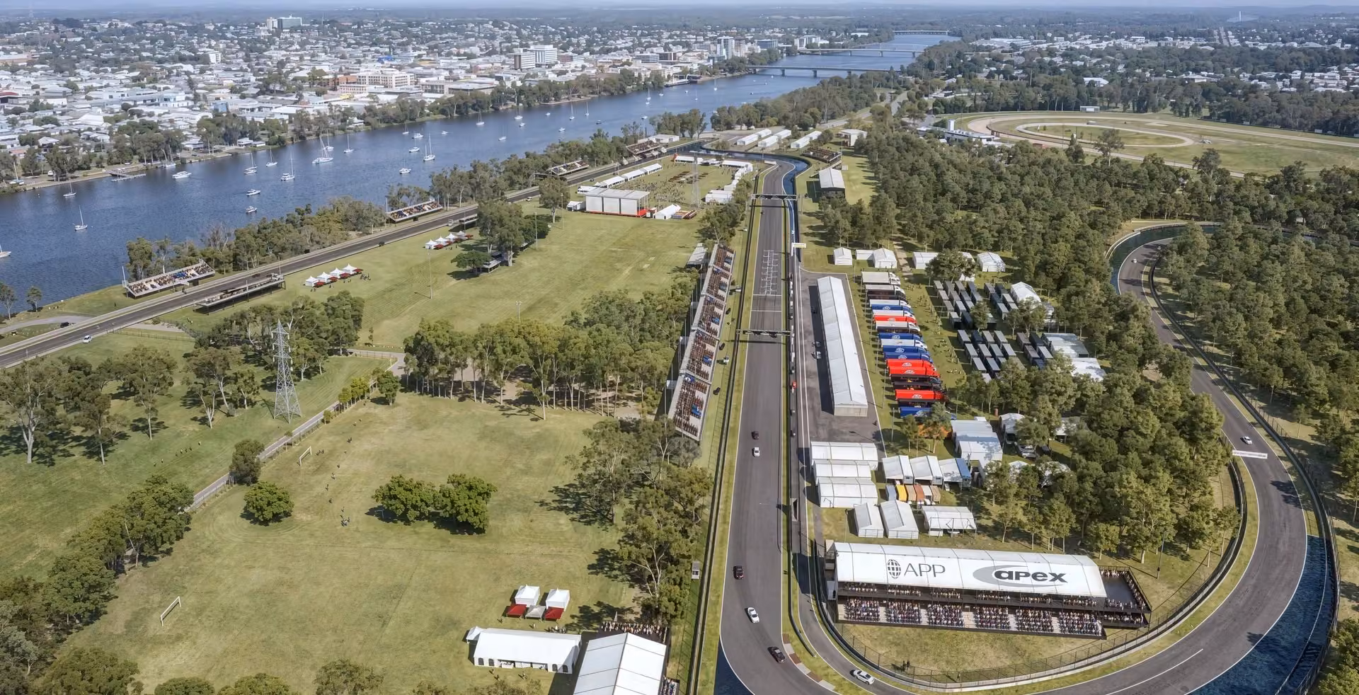 Aerial race track rendering along a riverside with grandstands, pit lane, and green landscapes — produced with 3D exterior rendering services.