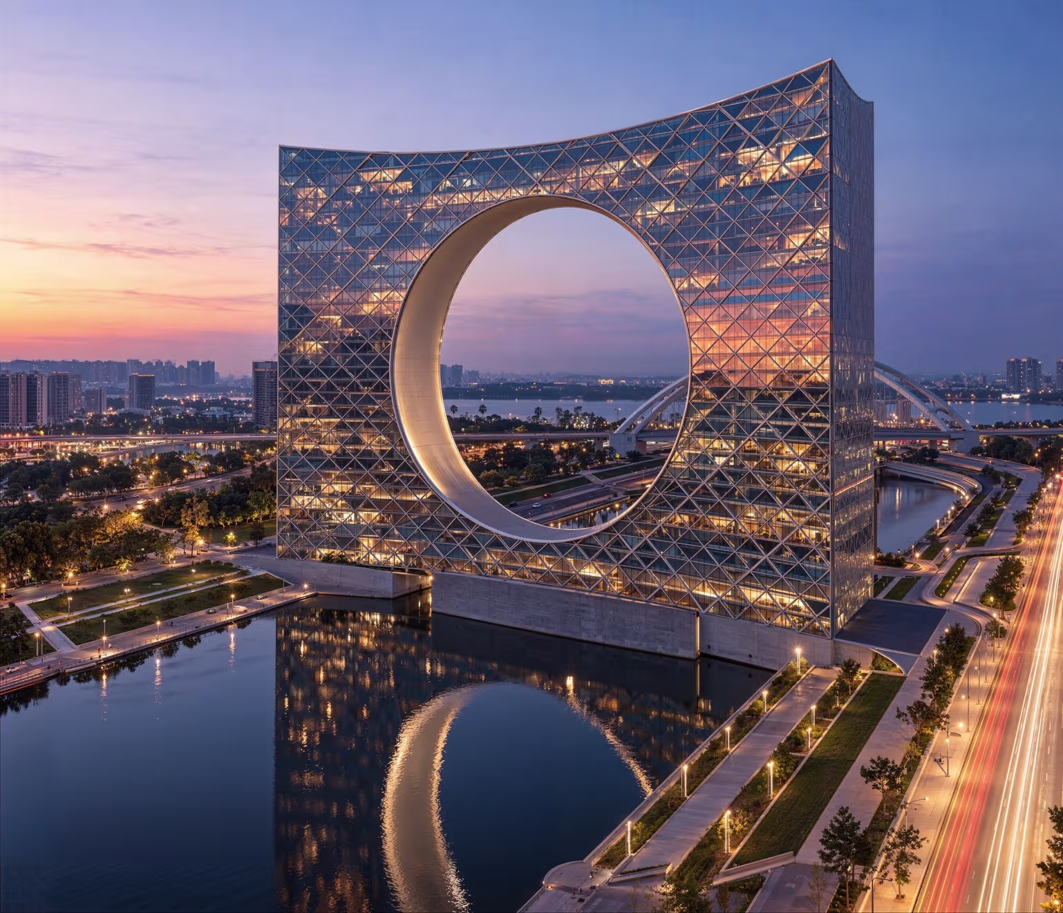 A commercial architectural 3D rendering of a futuristic high-rise building with a circular cut-out design, reflecting on a tranquil waterbody, surrounded by a cityscape illuminated in twilight.