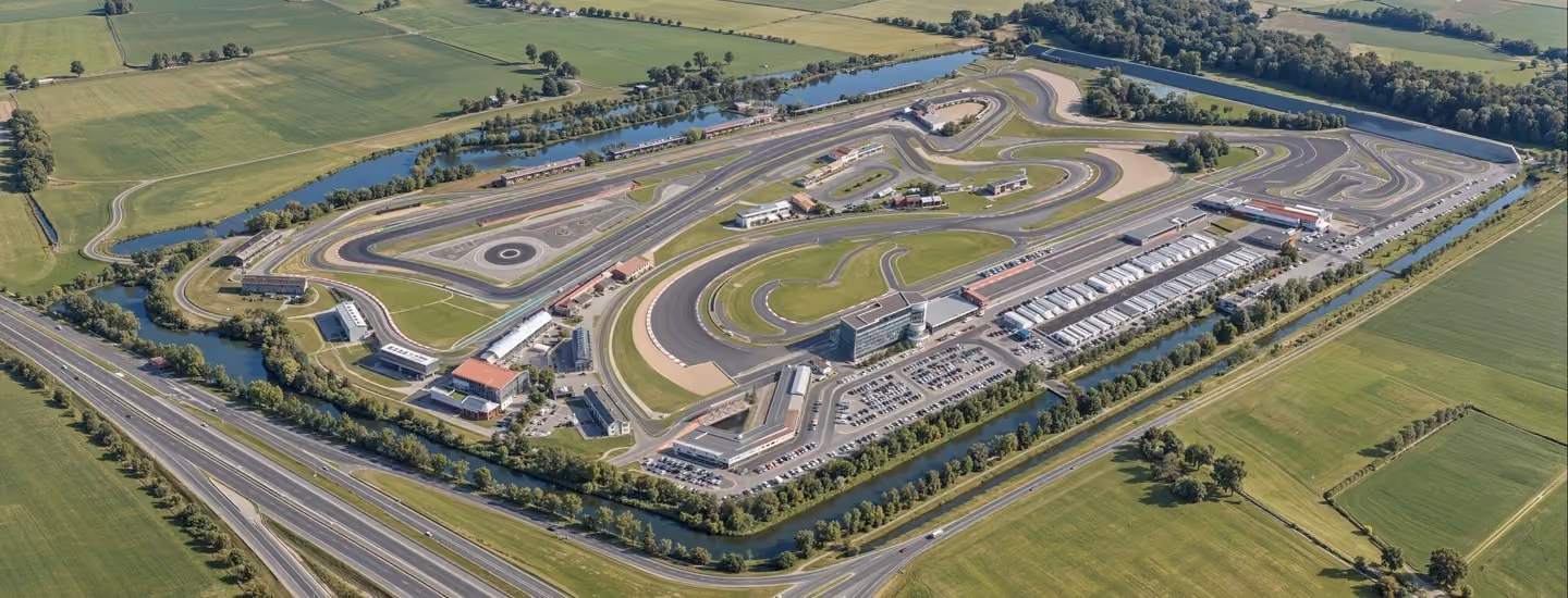 3D rendering in Adelaide of a large motorsport circuit masterplan featuring winding tracks, grandstands, and surrounding countryside.