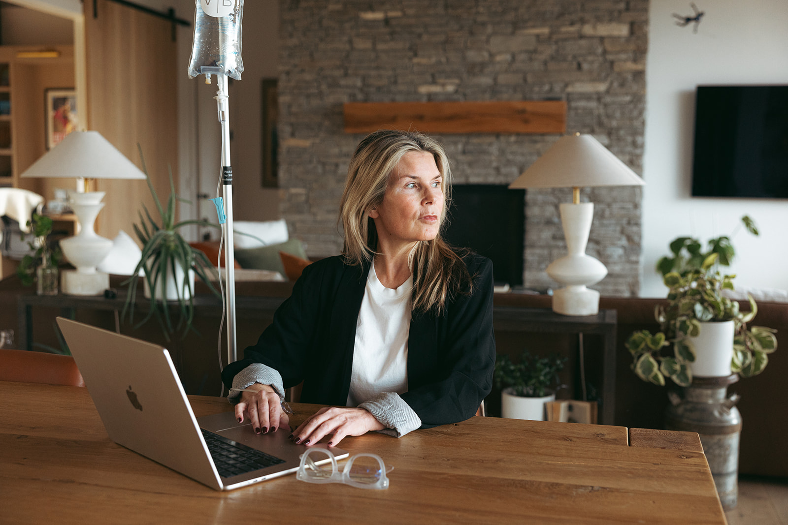 a nurse checks on a seated woman's iv 