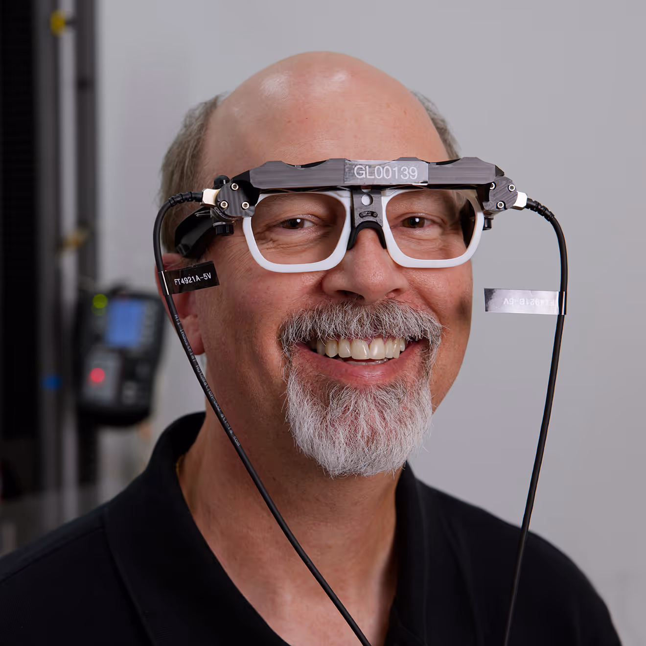 A Magic Leap employee smiles at the camera while wearing a device prototype.