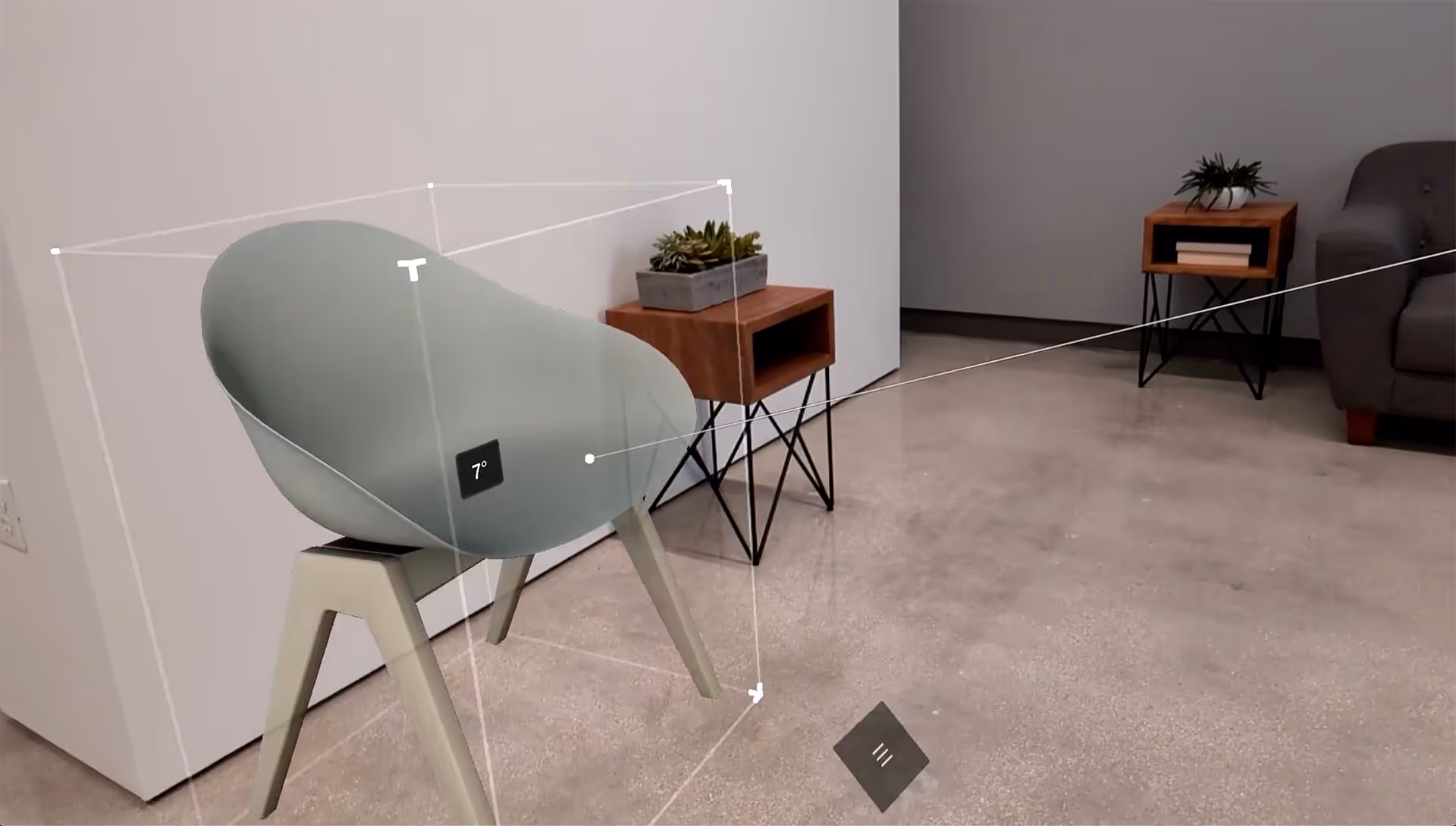 A woman places augmented reality furniture in a living room.