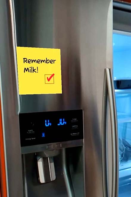 A link card element: An AR grocery list reminding someone to get milk on the refrigerator.