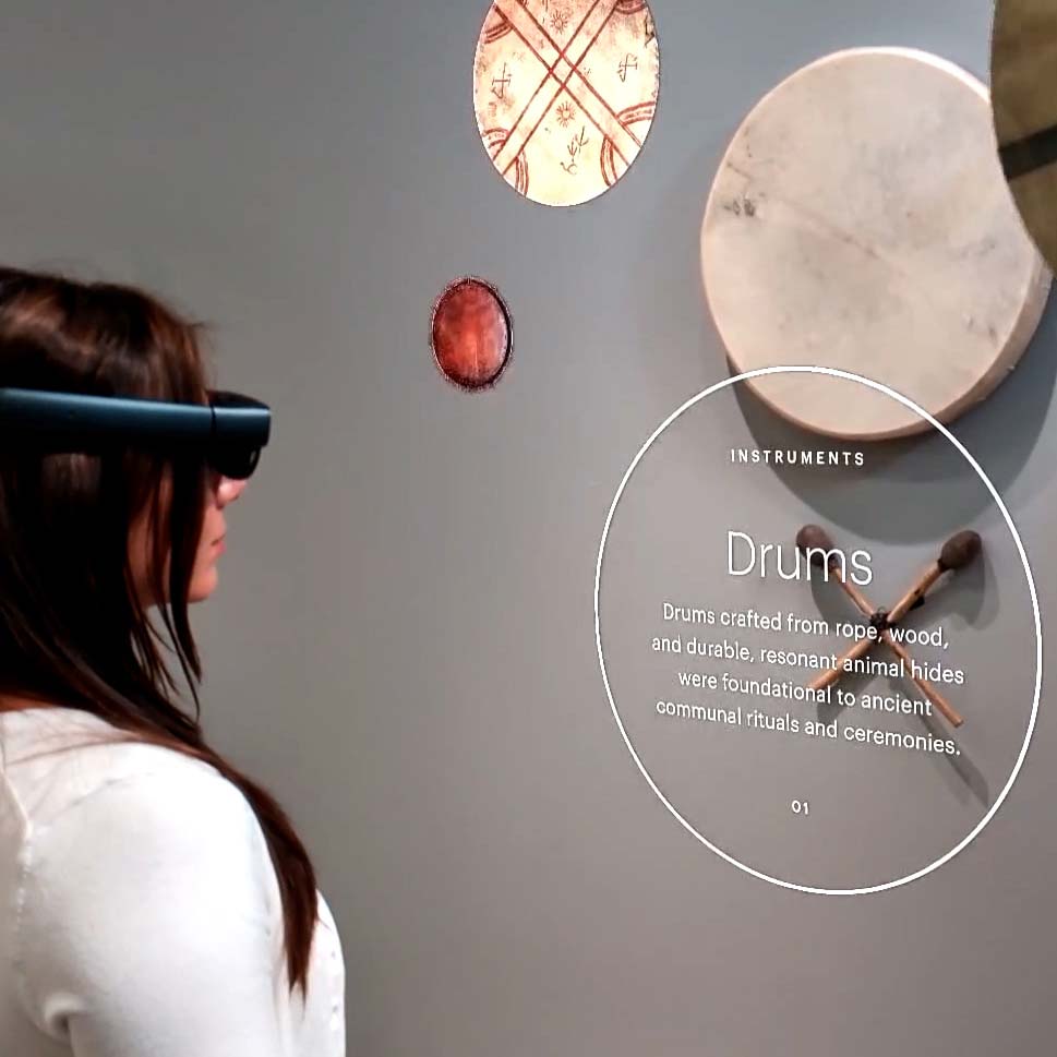 Woman in an AR headset experiencing augmented reality in a museum.