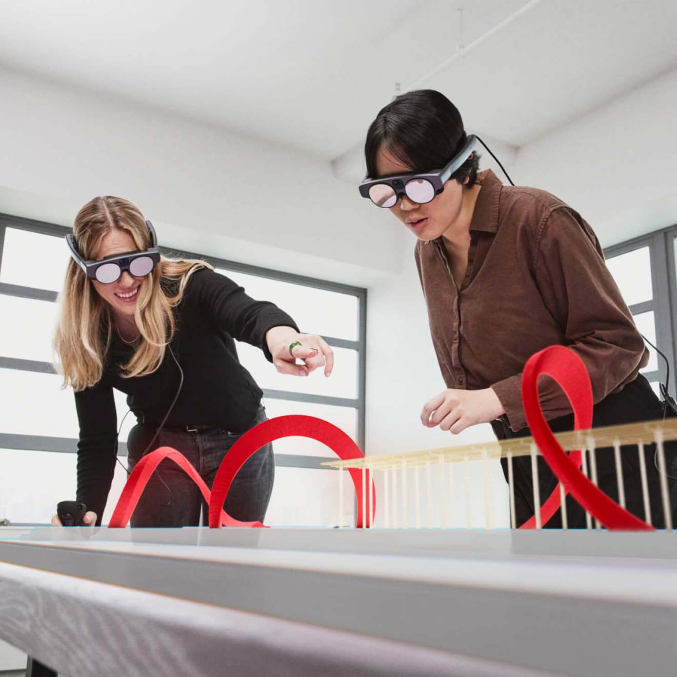 Two users wearing Magic Leap AR headsets to collaborate on a project.