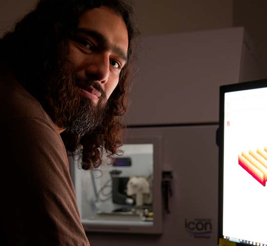 A Magic Leap technician reviews data readouts during the waveguide testing and manufacturing process.