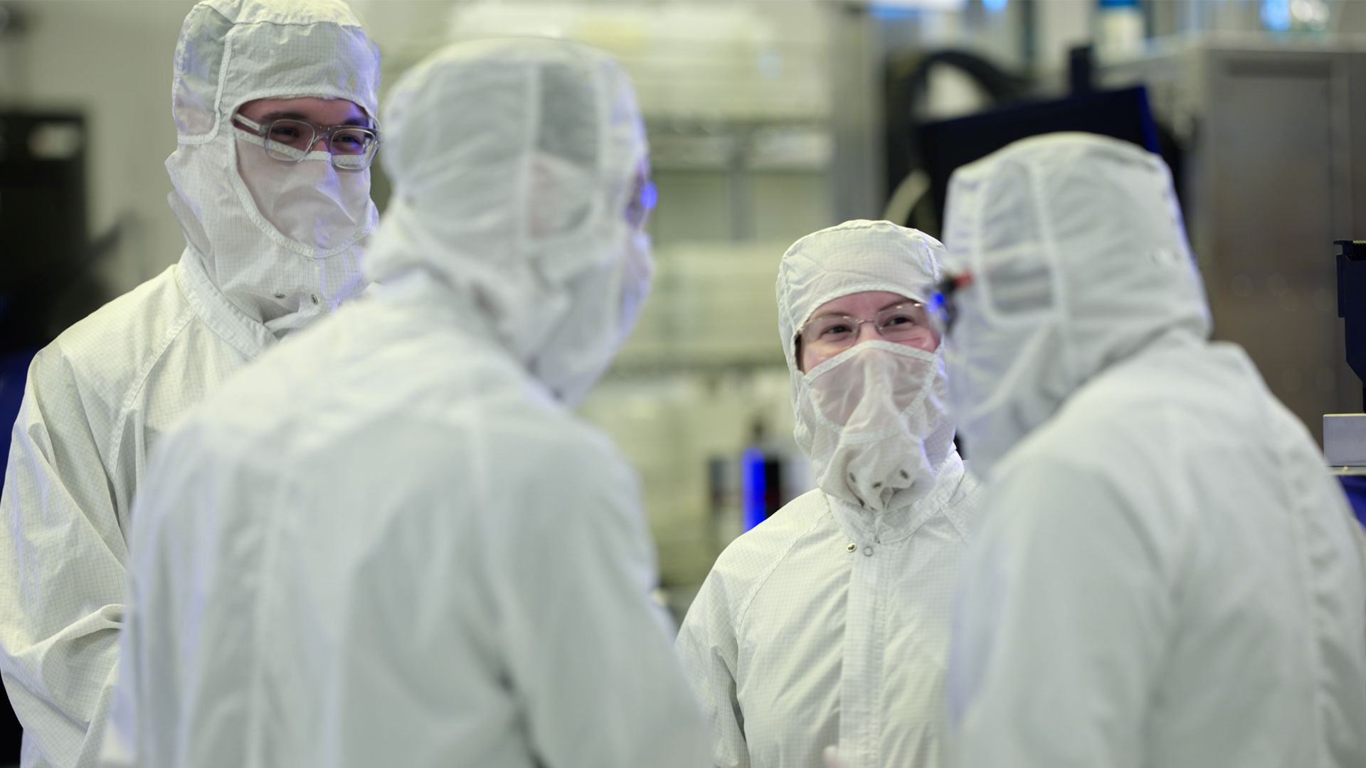 Magic Leap engineers discussing waveguide production in a clean room.
