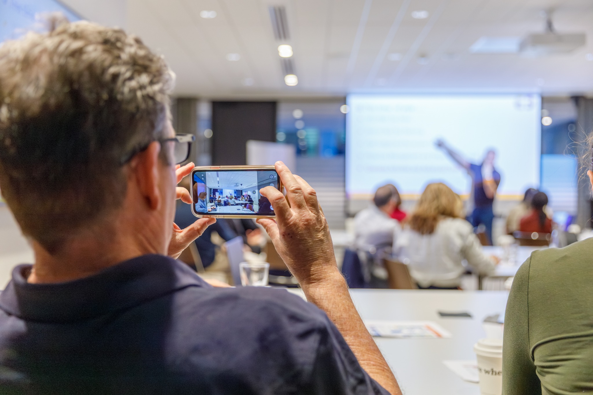 An attendee photographing a presentation at the 2026 Innovate Medtech Masterclasses