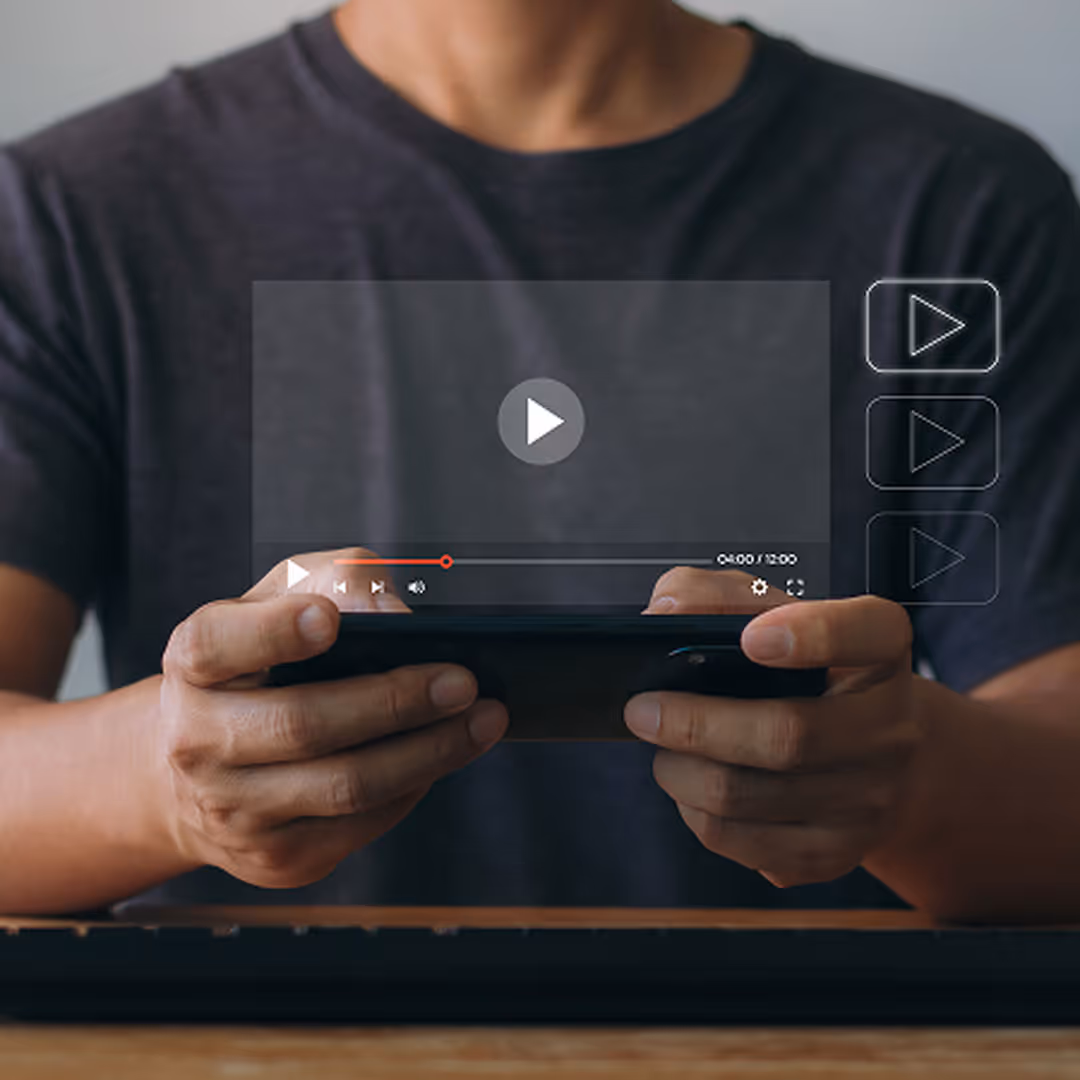 Person holding smartphone horizontally with a video player interface overlay on screen.