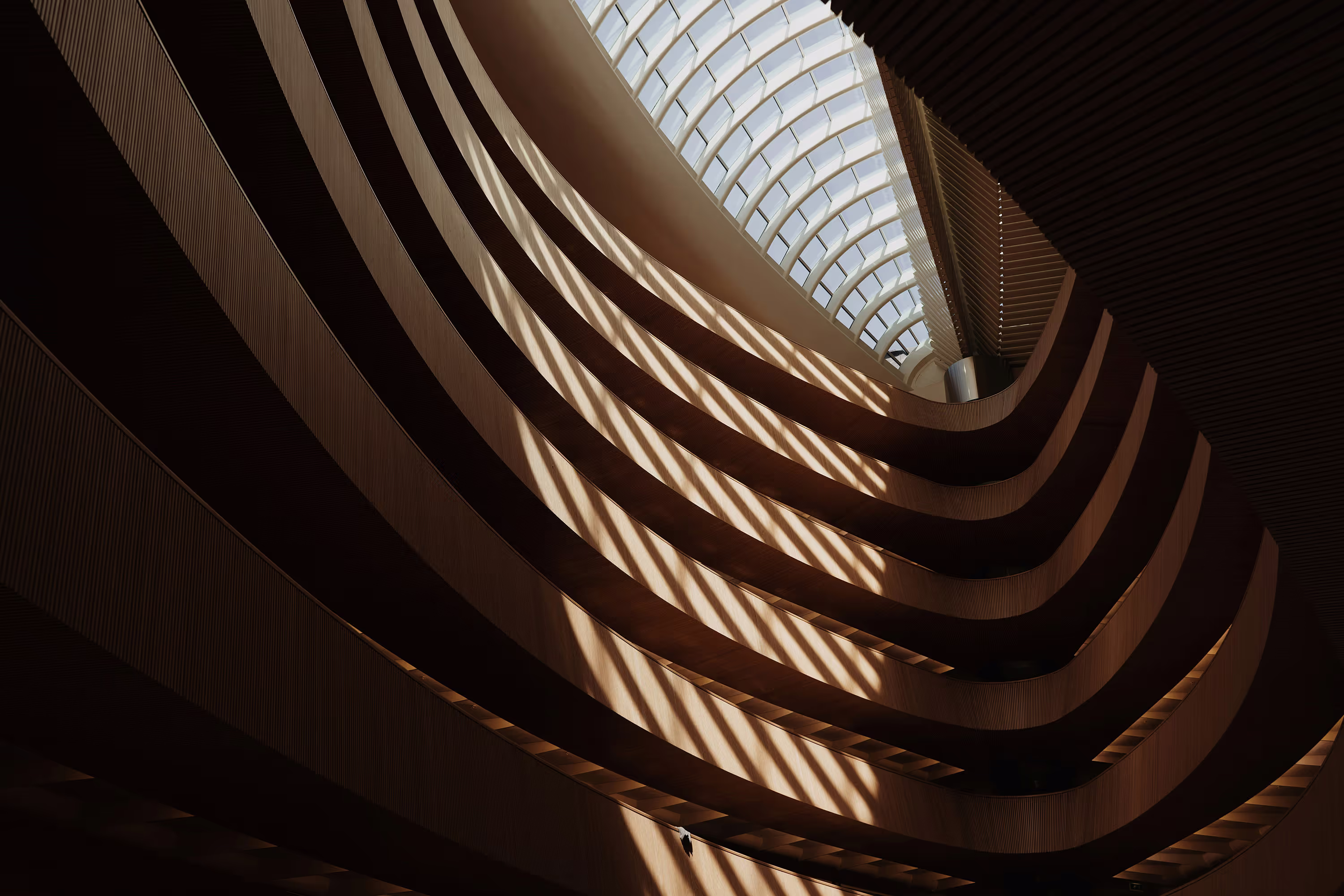 Interior view of a spacious area with multiple floors, featuring open balconies and walkways
