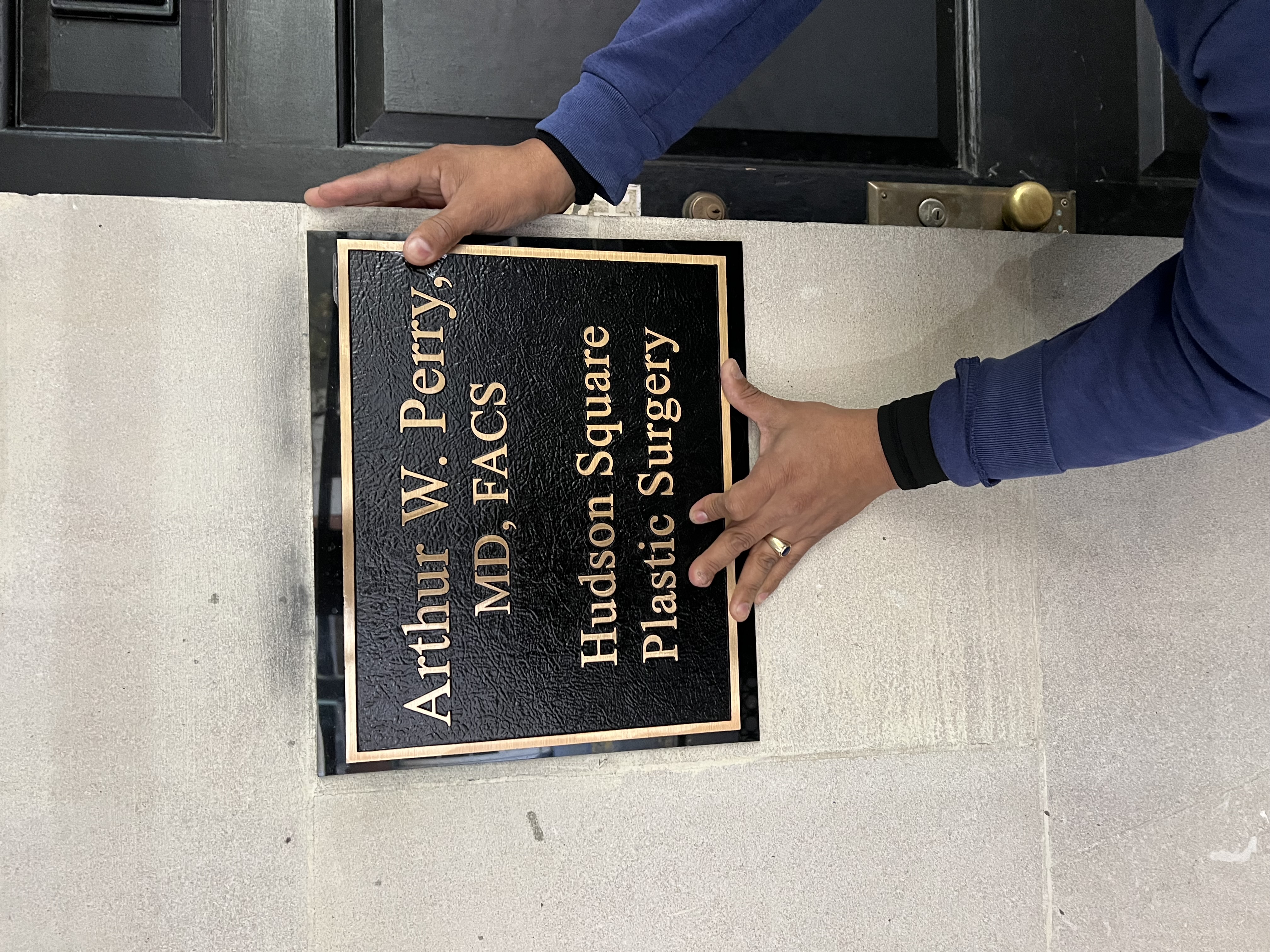 Office sign reading Arthur W. Perry, MD, FACS — Hudson Square Plastic Surgery