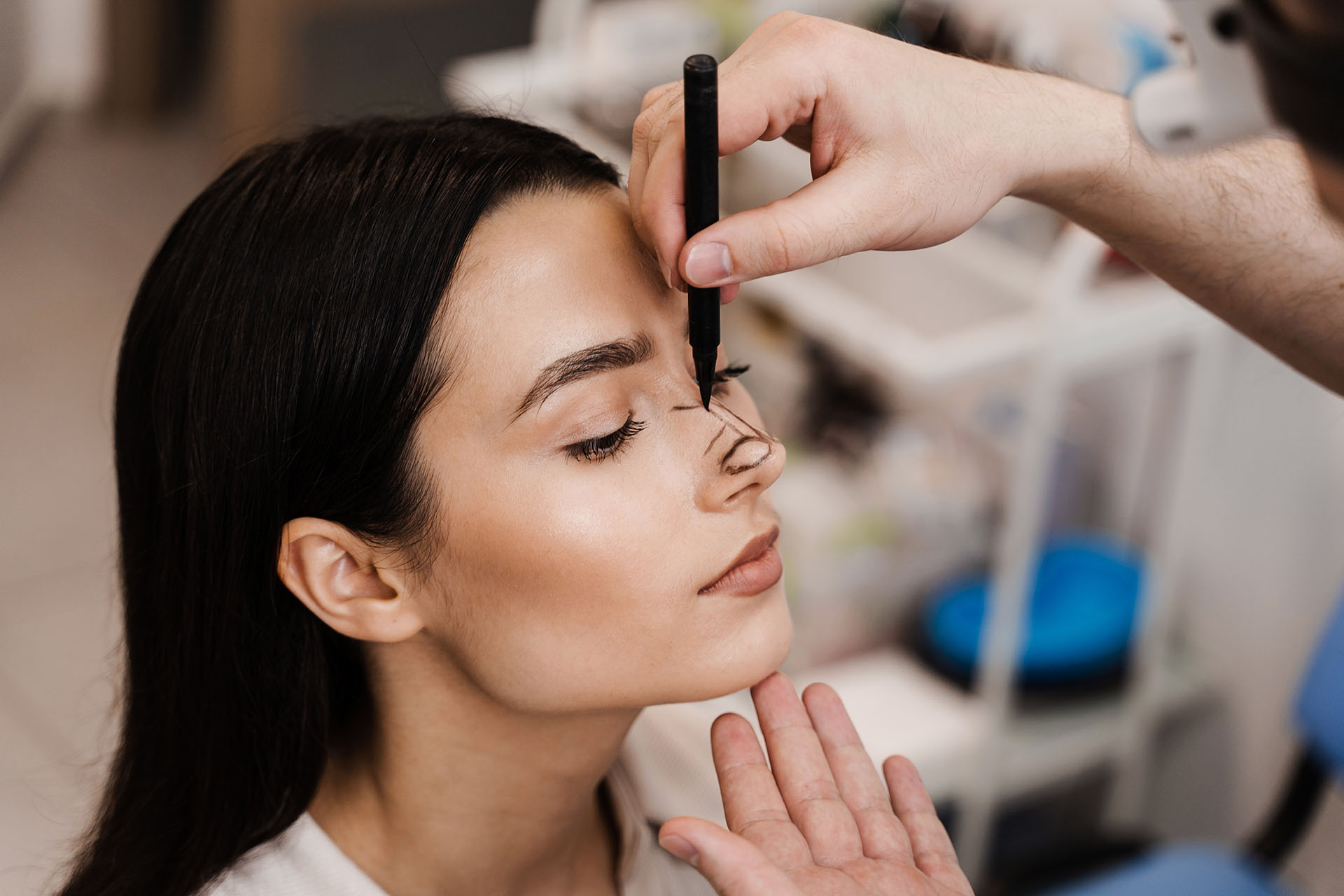Patient receiving a facial treatment with her eyes closed
