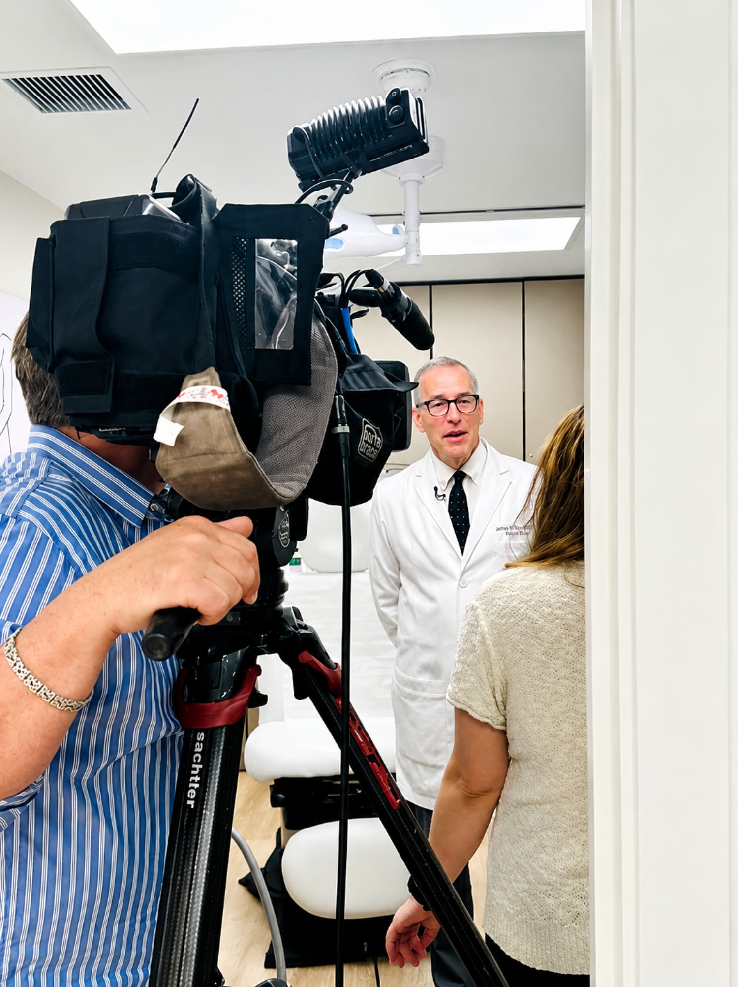 A television crew filming Dr. Arthur Perry on location