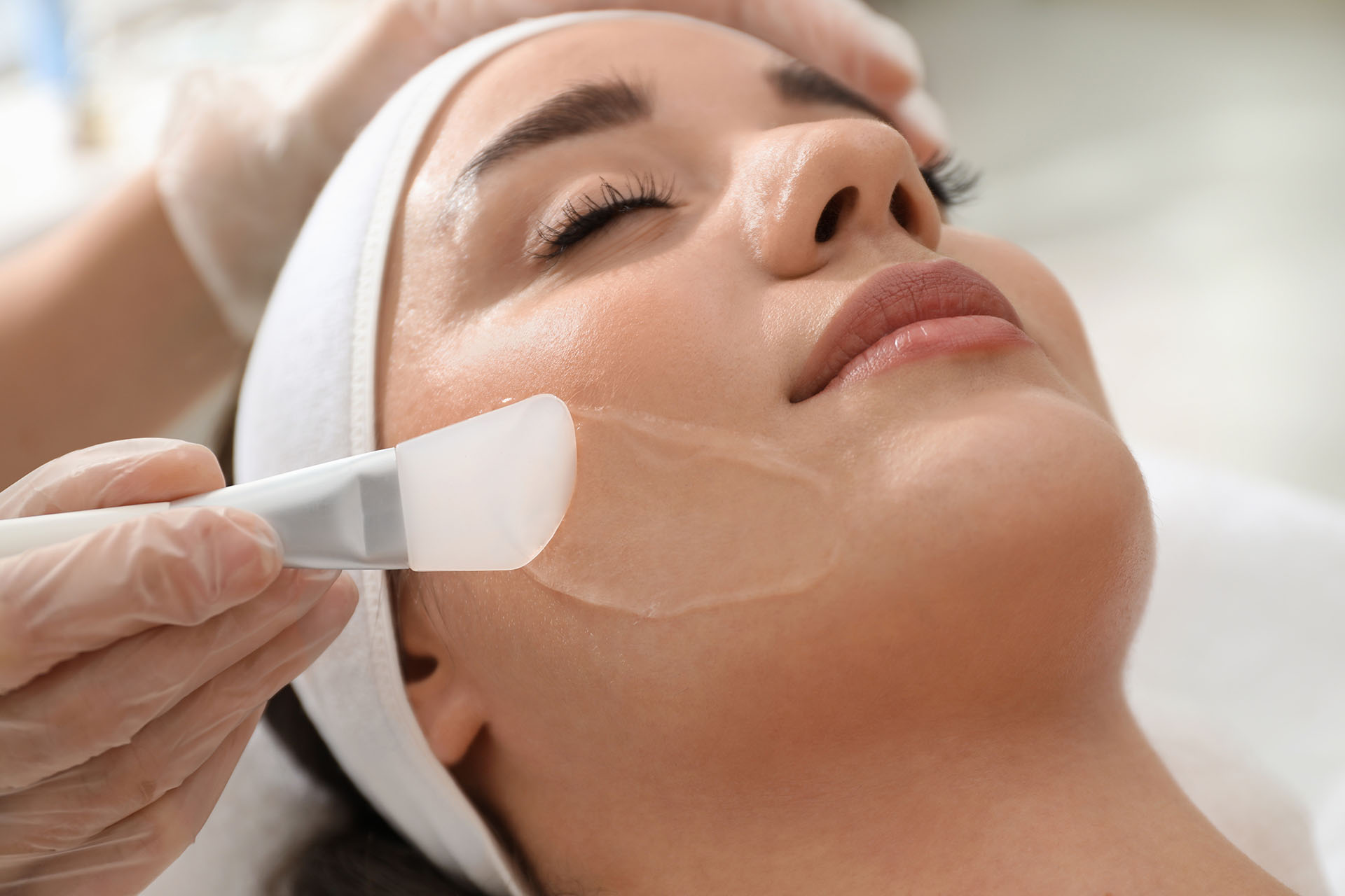 Close-up of a woman during a facial chemical peel procedure