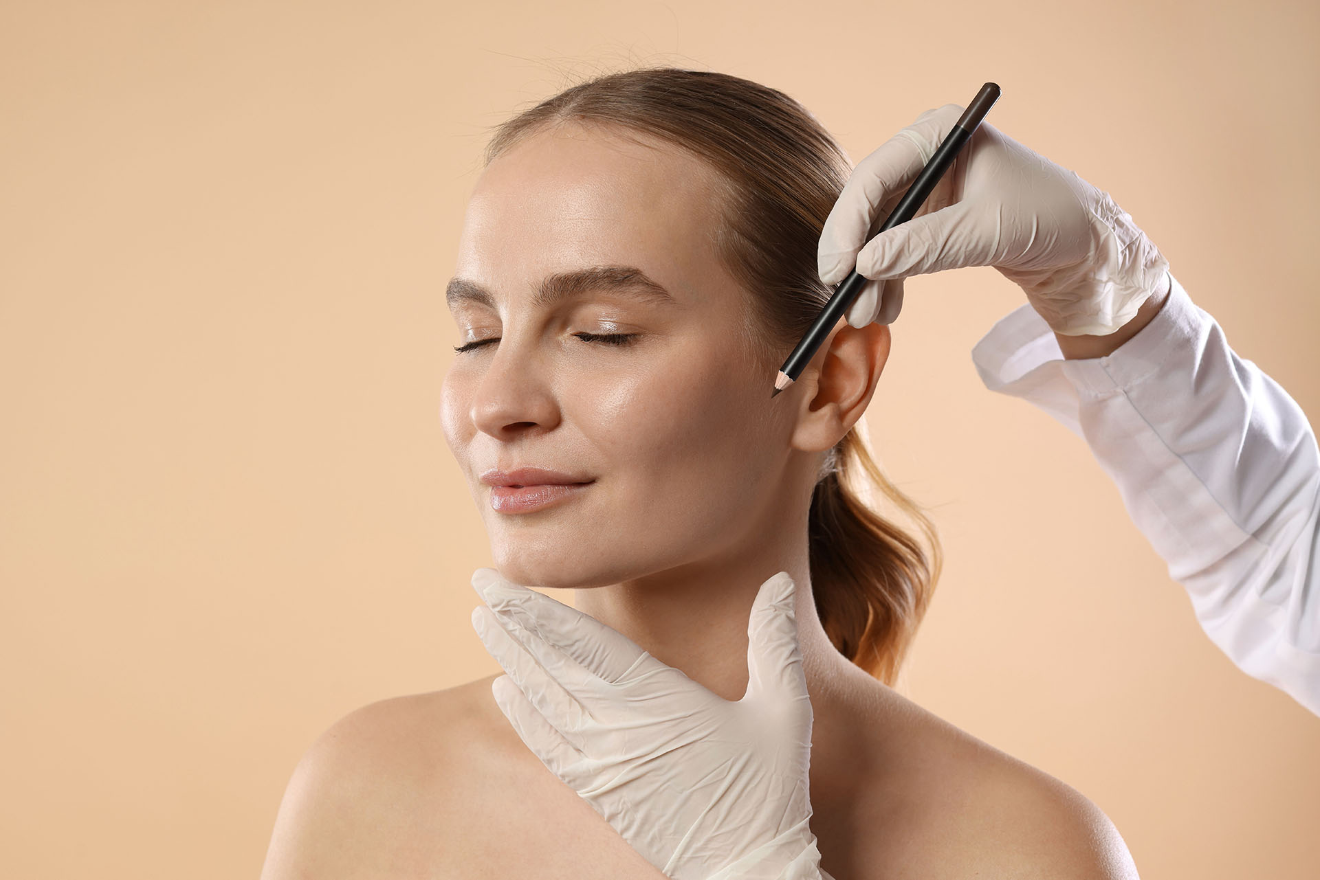 Doctor drawing surgical marks on a patient's face before a procedure