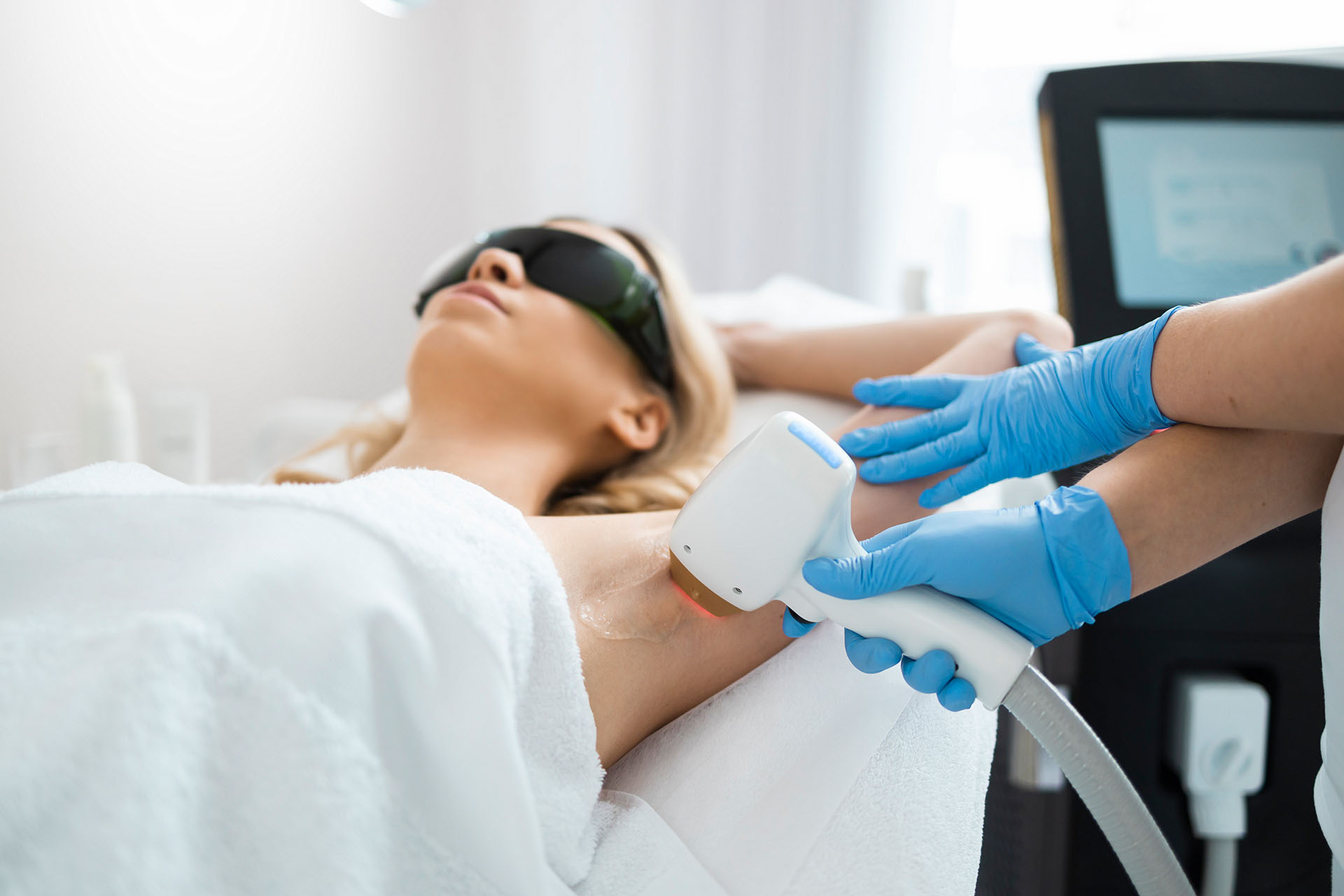 Underarm laser hair removal procedure in a beauty clinic