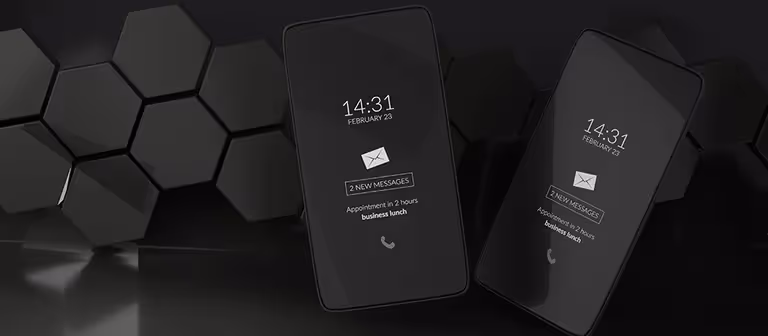 Black and white smartphones with lock screens showing time and messages
