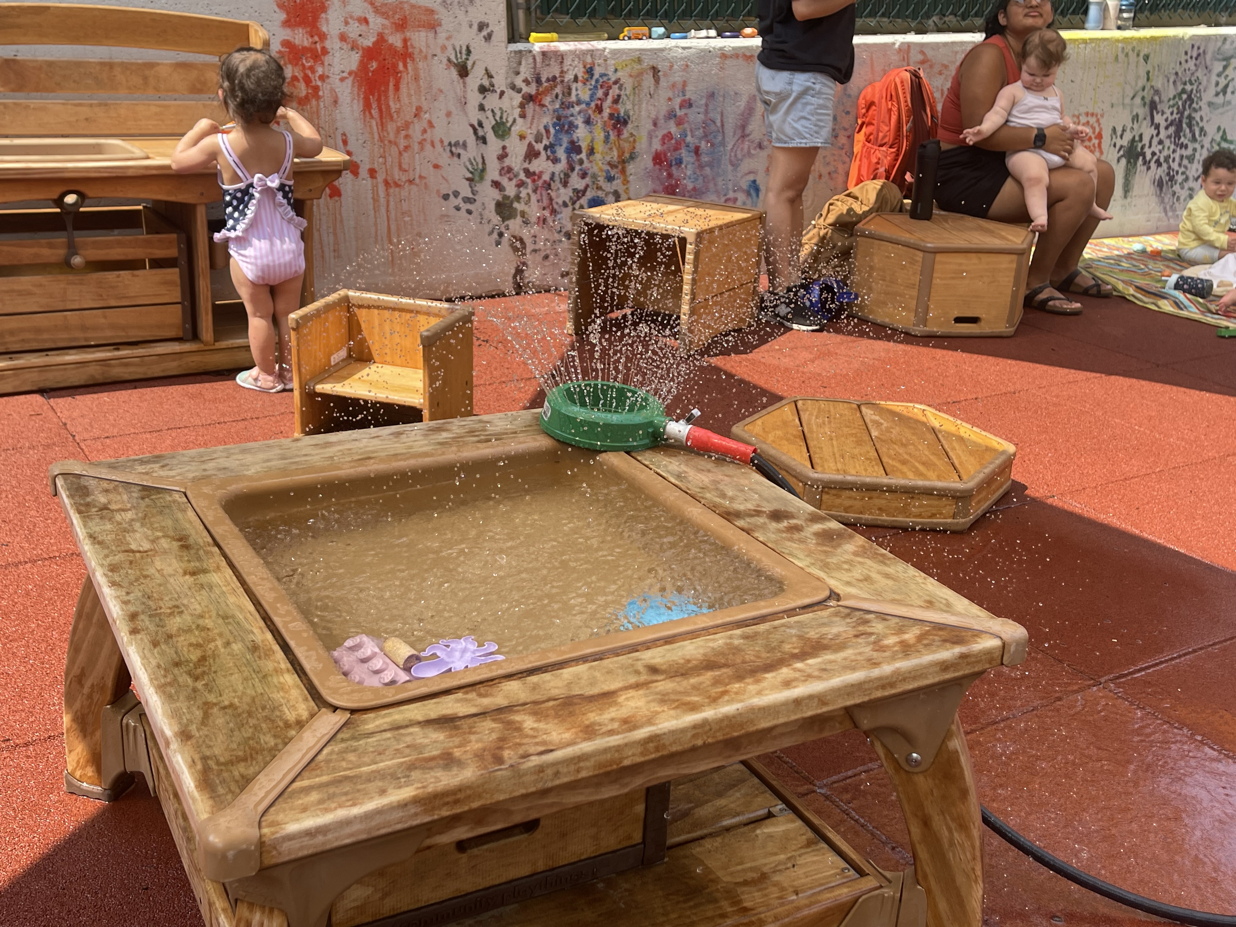 Outdoor area with water play at Kids' Canvas Grove street