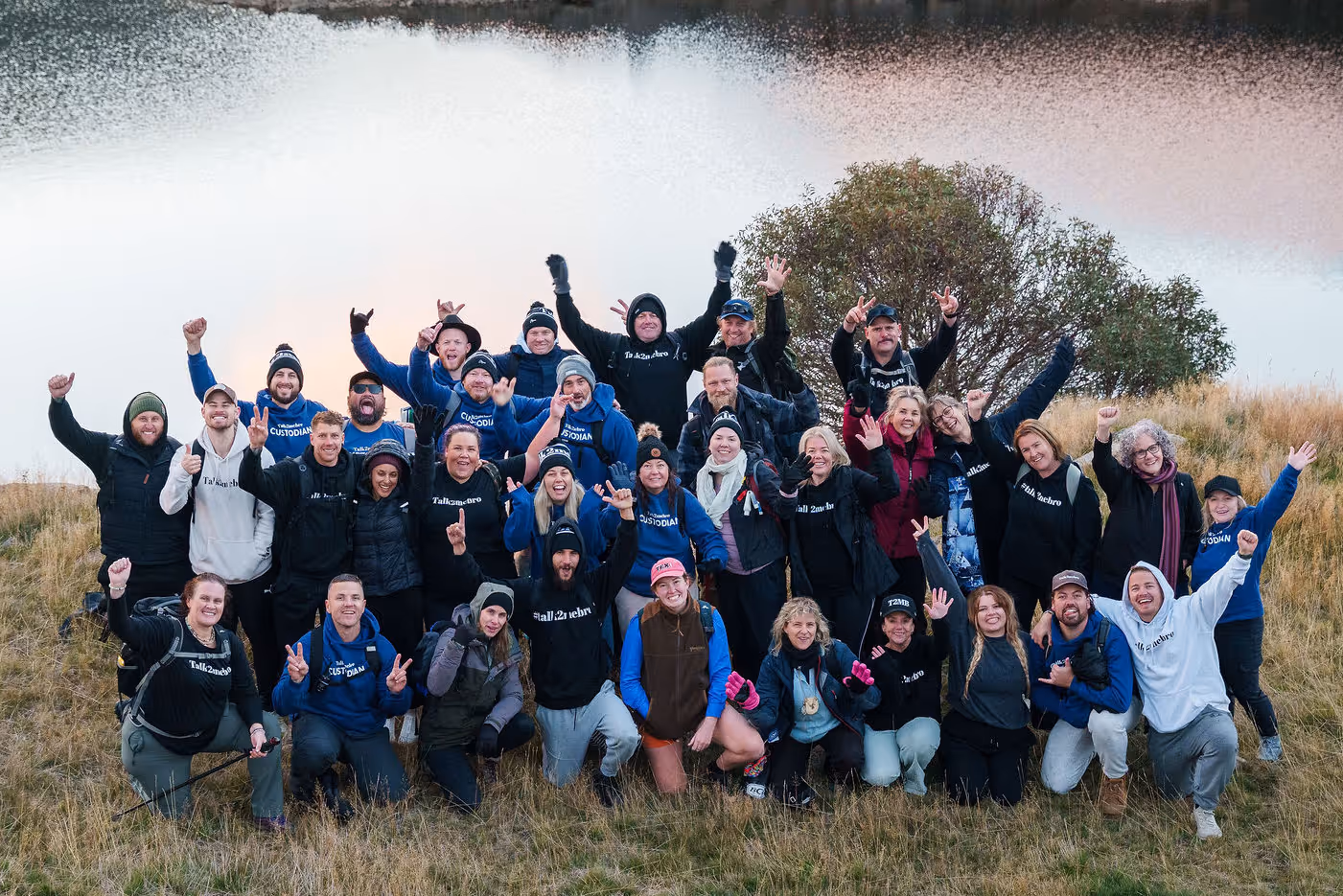A group of people posing smiling