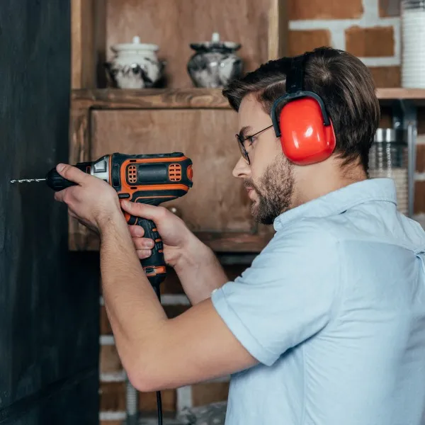 Worker using earmuffs