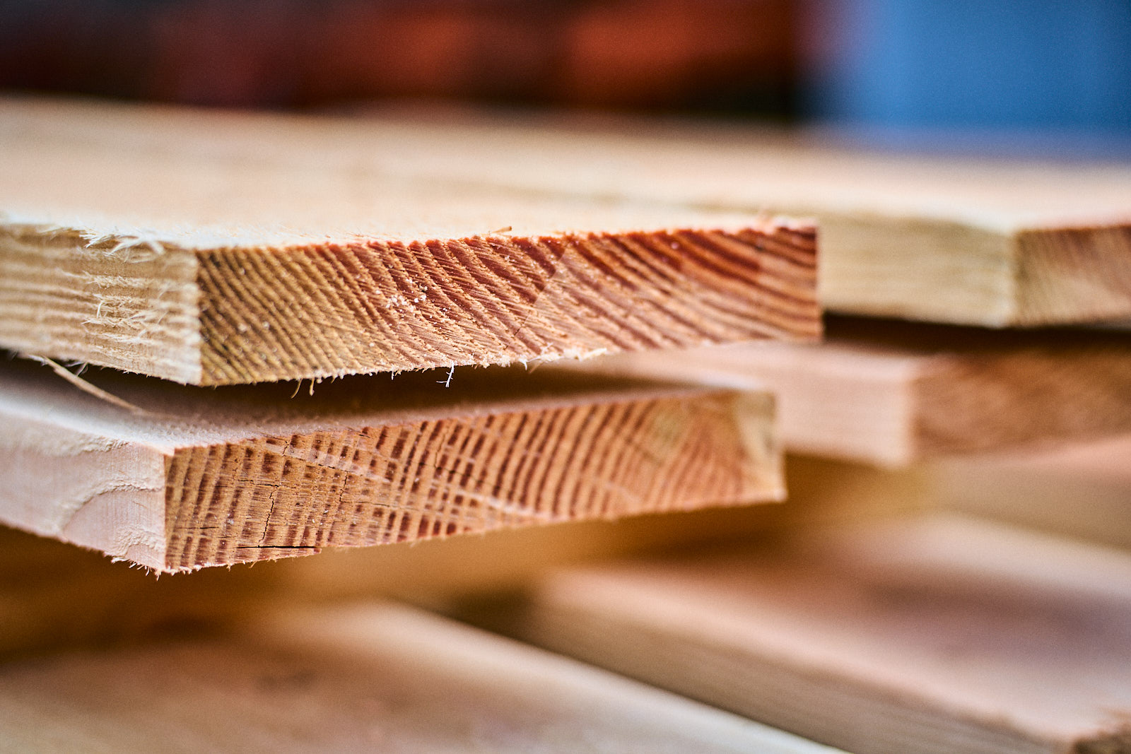 Close-up of stacked wooden planks showing grain and texture details.