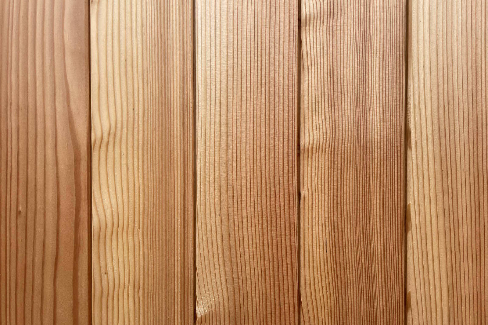 Close-up view of vertically aligned wooden planks with natural grain and warm tones.