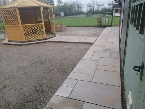 Slabbed path leading to gazebo in middle of cat enclosure.