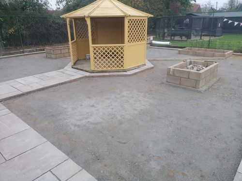 Slabbed path leading to gazebo in middle of cat enclosure.