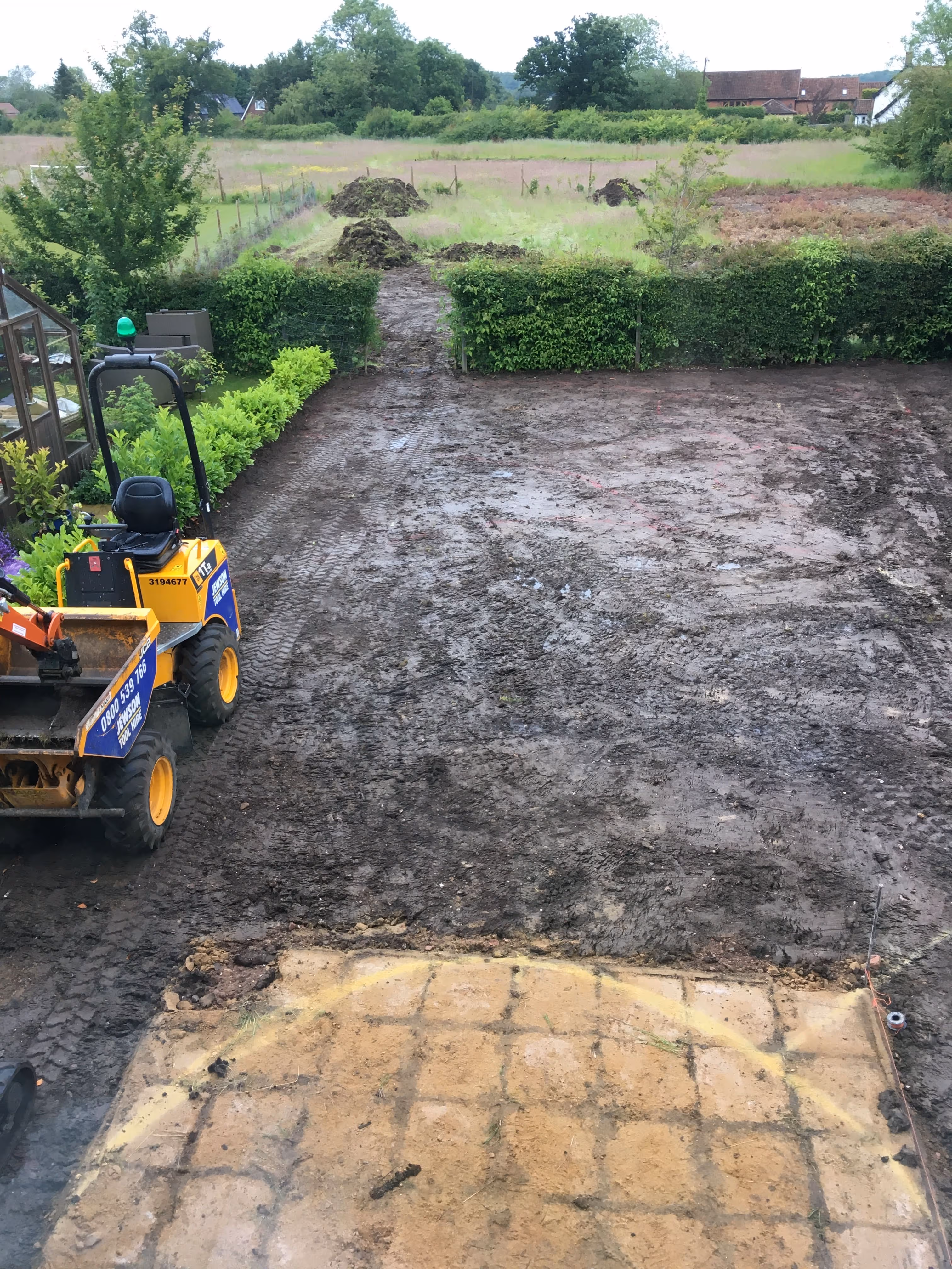 Back garden completely ripped up by digger just leaving the muddy top soil underneath and the old patio area.