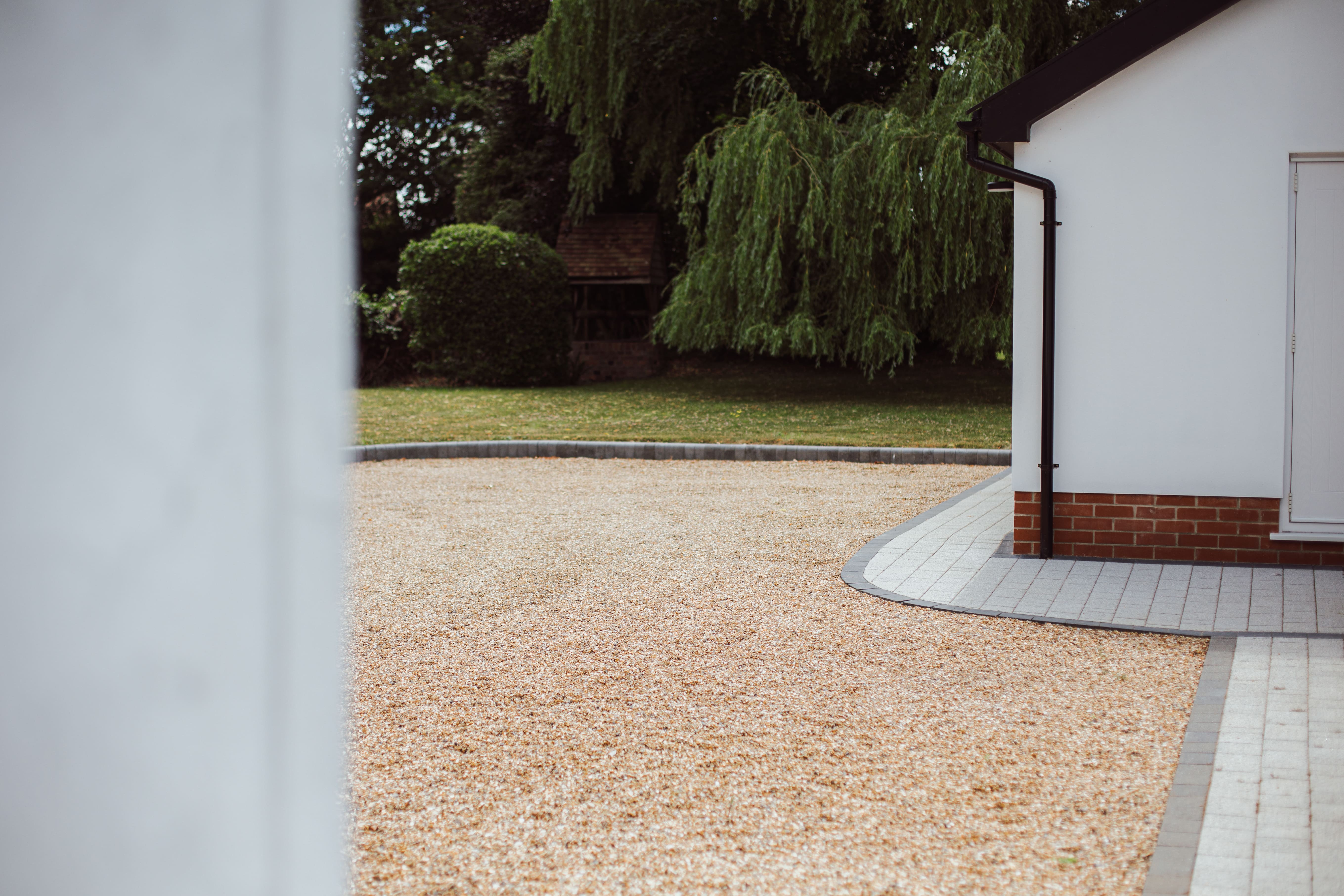 Angled view of the rendered white walls at Church Cottage.