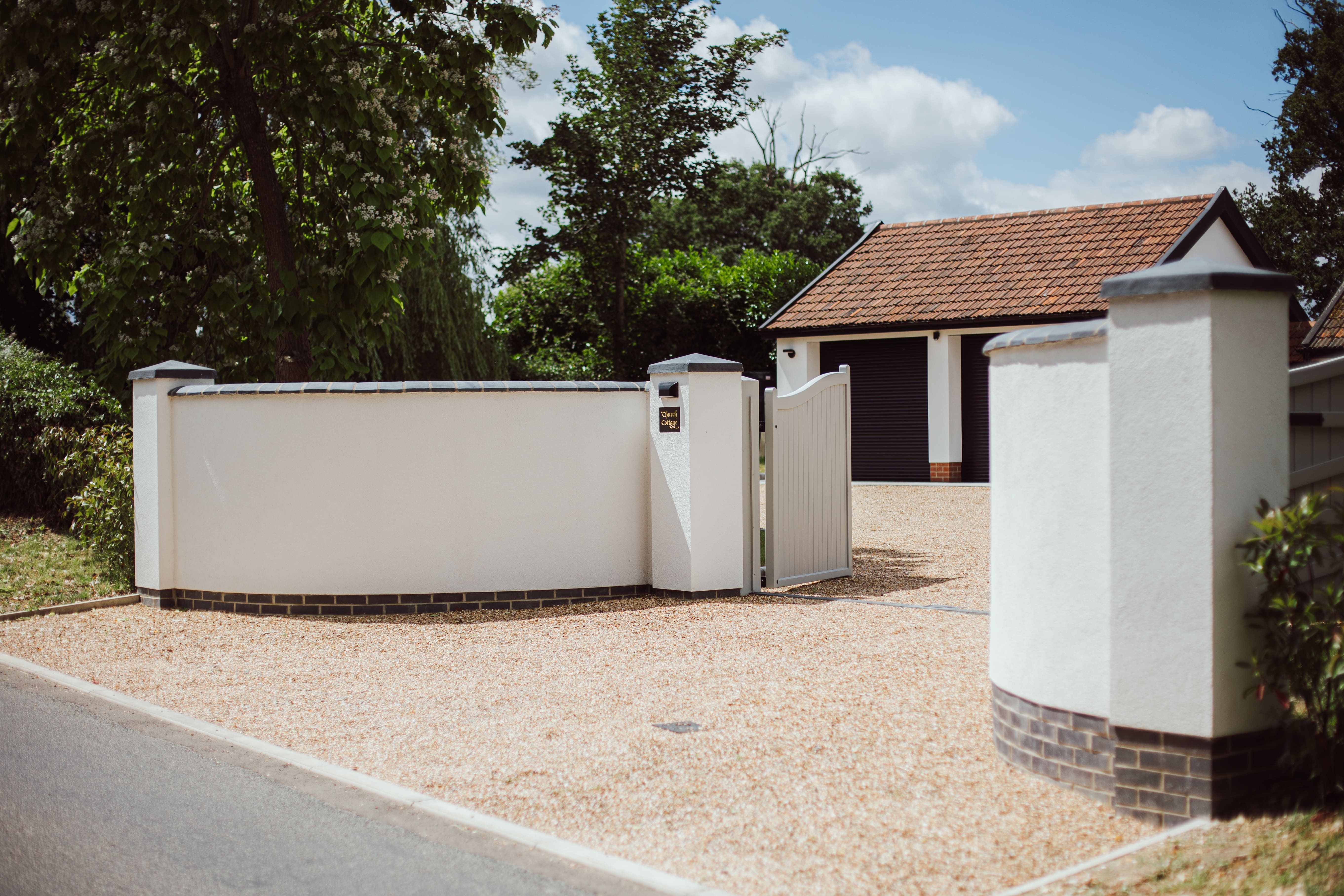 Front Street view of Church Cottage and the front gates. you can also see the gravel driveway and double garage.